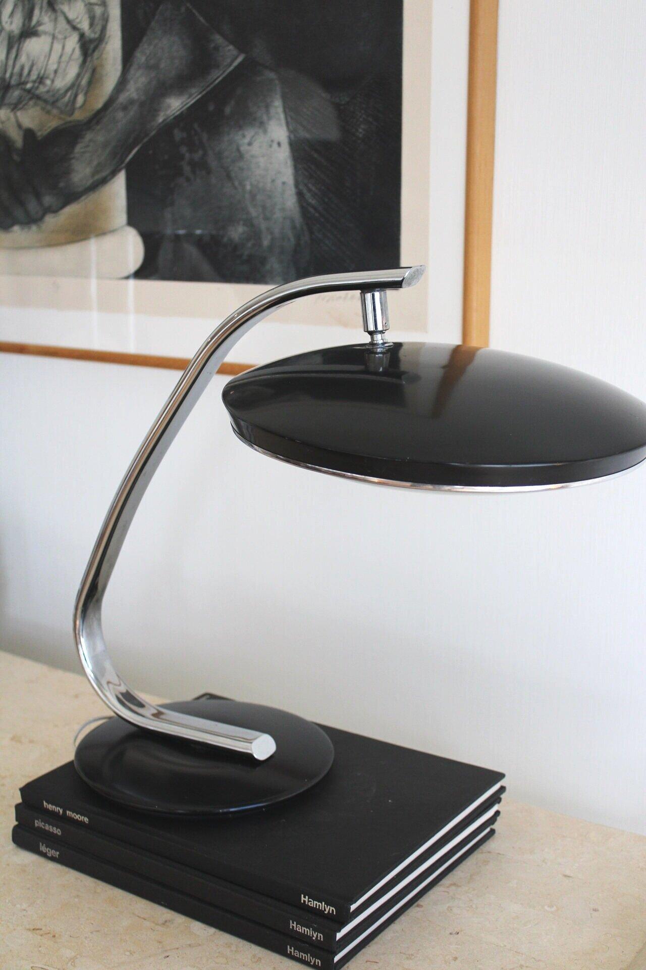 A sleek iconic design, highly sought after by collectors and designers alike by Martin Pedro. Originated from Spain. A beautiful mix of metal, chrome and glass diffuser that allows a soft glow. produced until 1980s. featuring clean lines, ball joint
