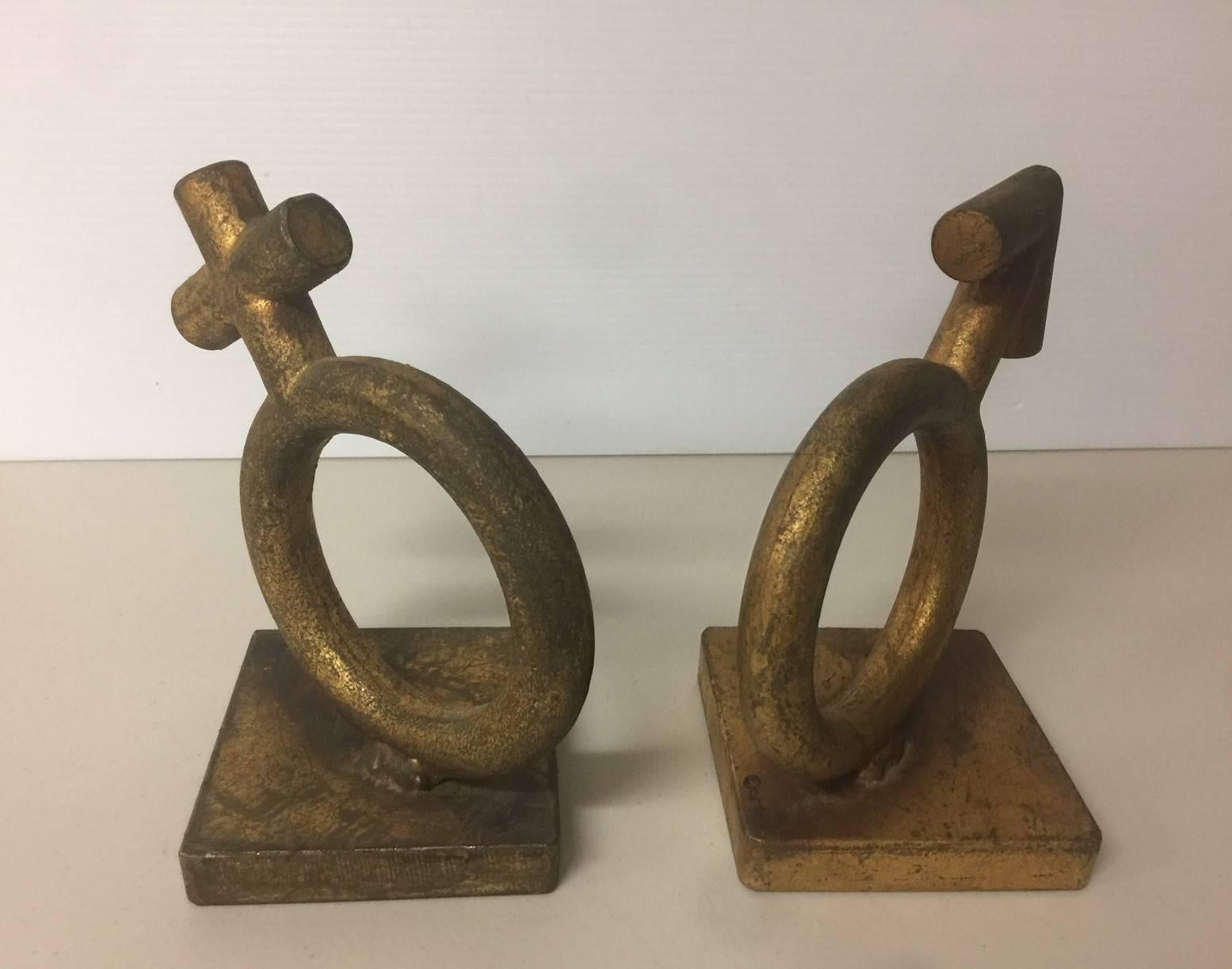 Original pair of midcentury sculptures / bookends featuring the universal symbols for male and female (Sexes) signed by C. Jere, circa 1960s 

The pieces are made of heavy metal with a gold leaf-like finish and have a wonderful, worn vintage