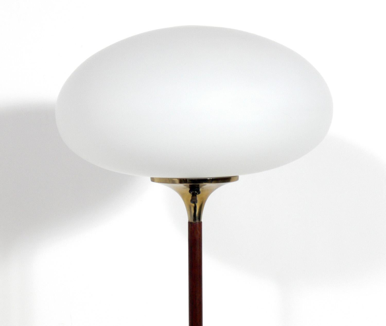 Iconic midcentury laurel floor lamp, executed in rosewood veneer, brass plated metal and original milk glass shade. Rewired and ready to use.