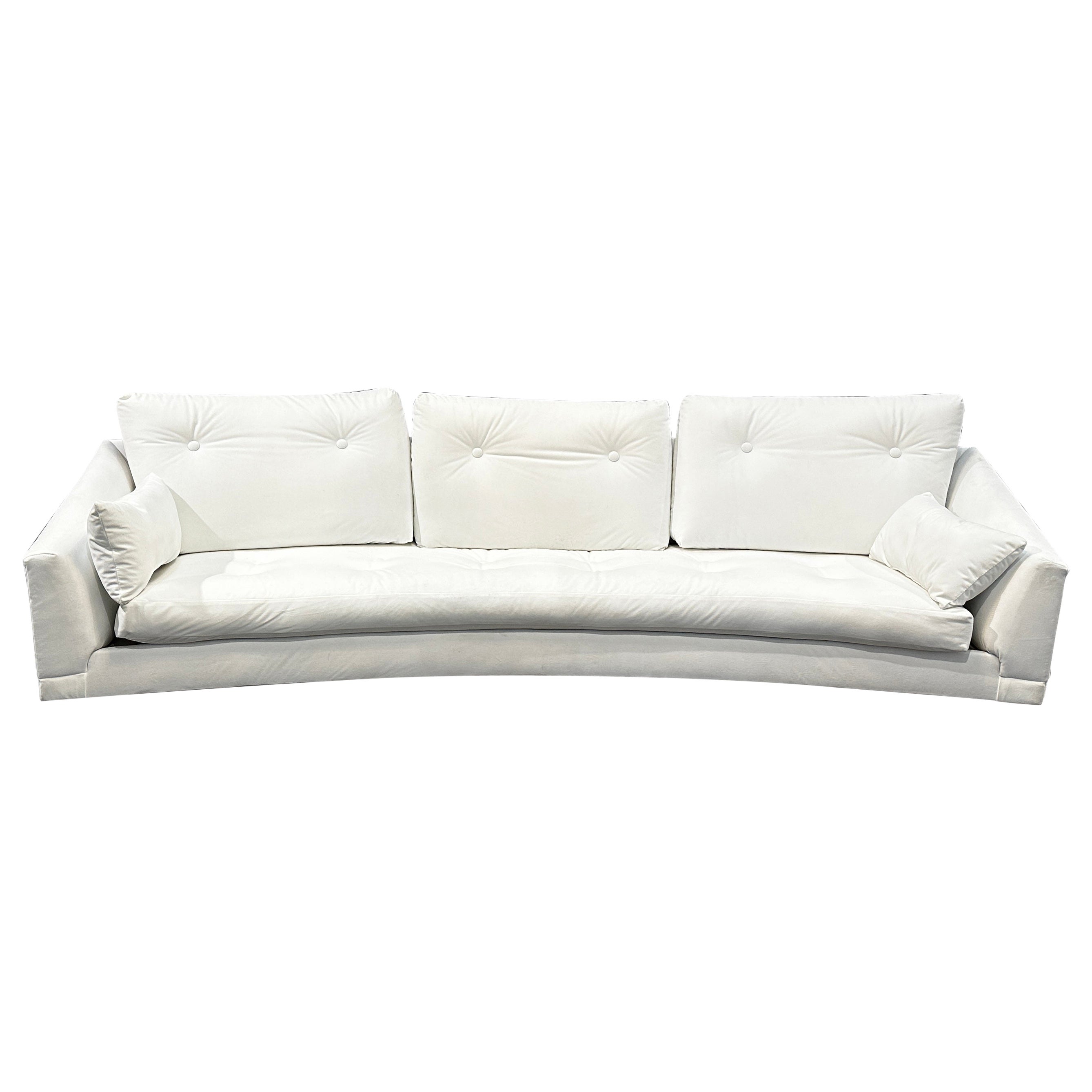 This Iconic and incredible low-profile Mid-Century Modern platform sofa is designed by Adrian Pearsall for Craft Associates. The back of the sofa is curved and sits on an amazing walnut plinth base. The piece is Fully reupholstered in white