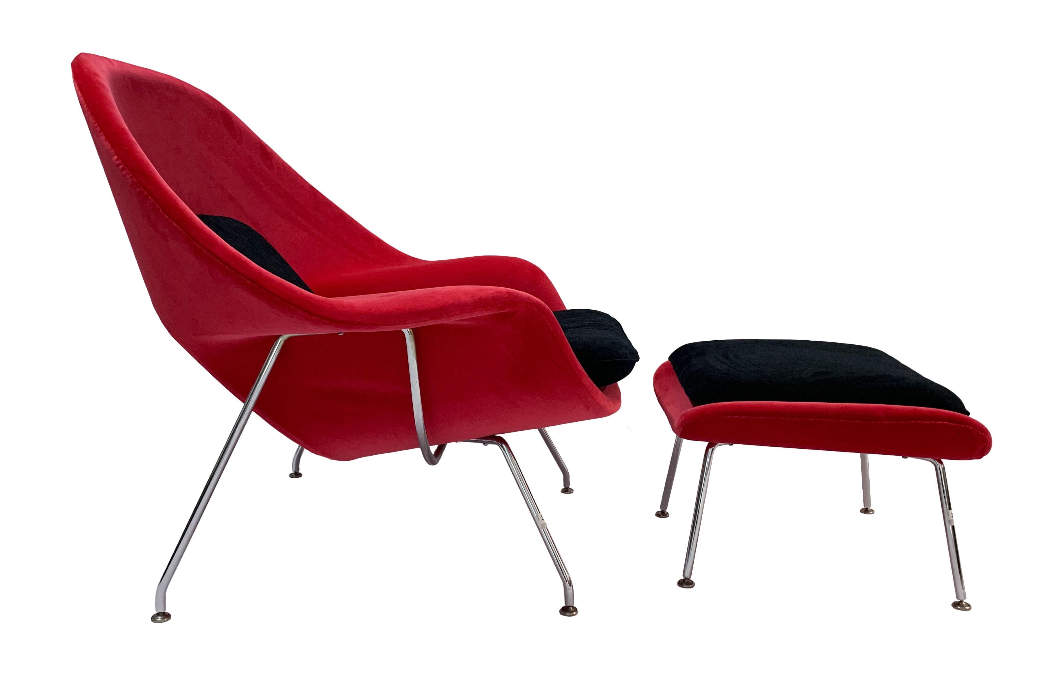 Iconic Mid-Century Modern Knoll womb chair and ottoman. Fully refurbished and reupholstered in a feisty Bernard Velluti red velvet with back and seat cushions in a Carlucci black velvet. The ottoman is covered in red velvet with a black cushion