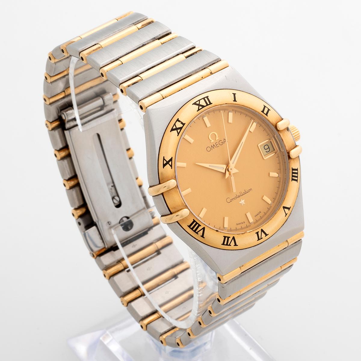 Our iconic Omega Constellation, reference 396.12.01, features a 33mm stainless steel and 18k yellow gold case and desirable stainless steel and full bar 18k yellow gold bracelet. This example distinguishes itself by its rare textured champagne dial,