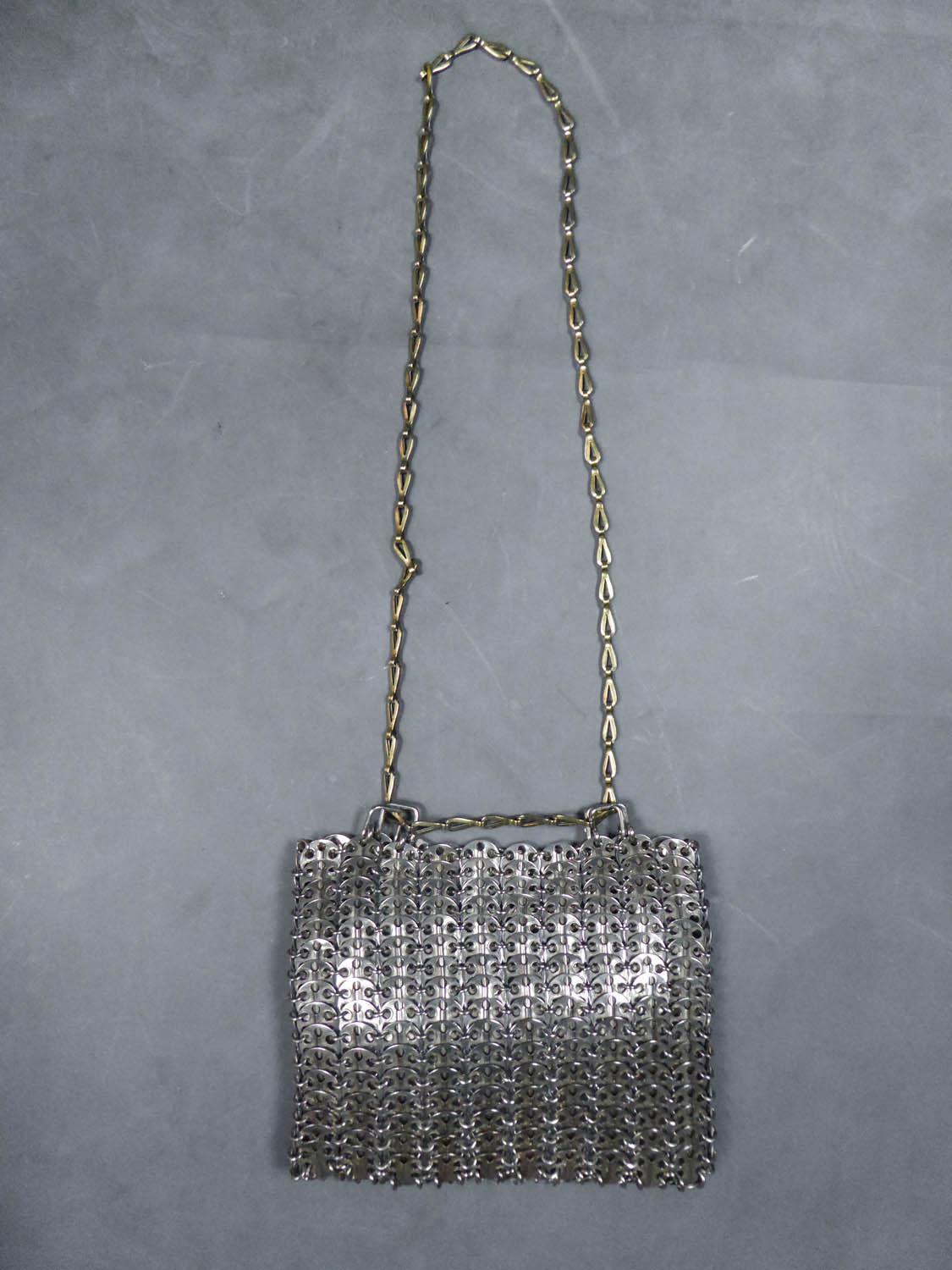Circa 1968
France

Iconic Designer's bag or purse from the first period of the designer Paco Rabanne at the end of the 1960's. Assembly of perforated steel discs placed on other steel discs and connected by rings. Retained by a sliding chain of