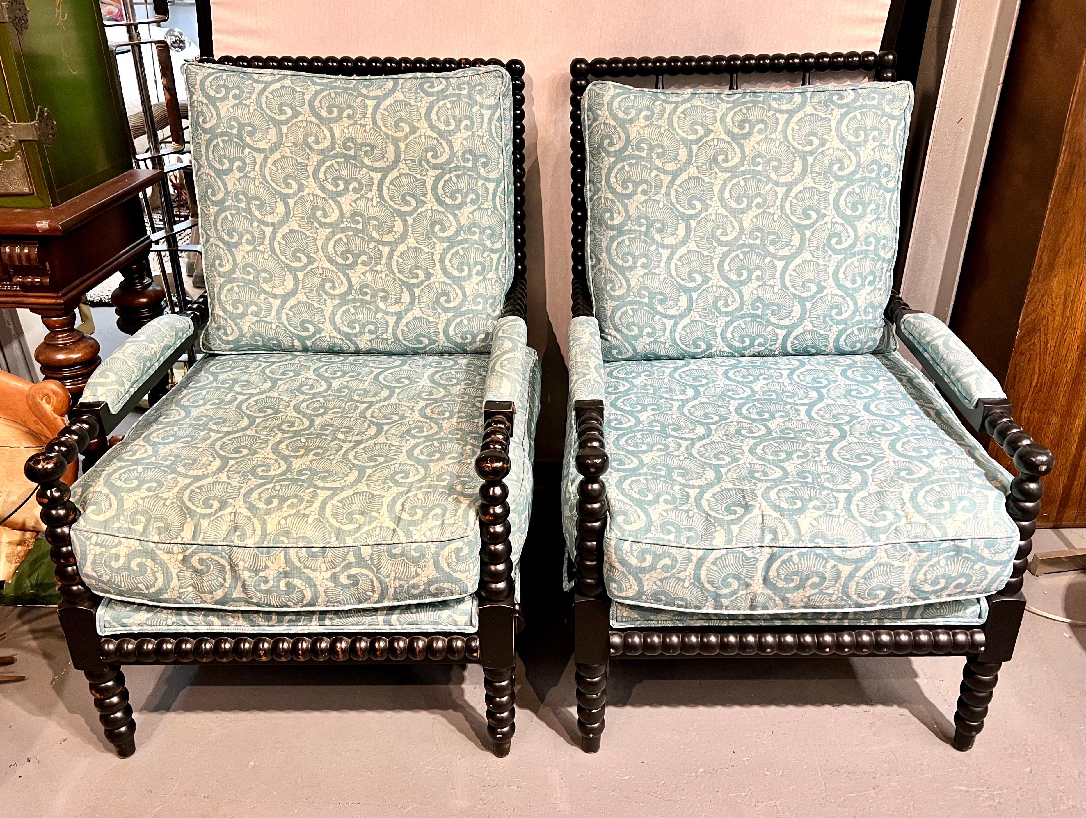 Magnificent pair of spool arm chairs with the same turned wood detail of 17th century bobbin furniture. Has turquoise paisley print upholstery which is not original to the set but rather done about 5 years ago. Coveted barley twist carved wood
