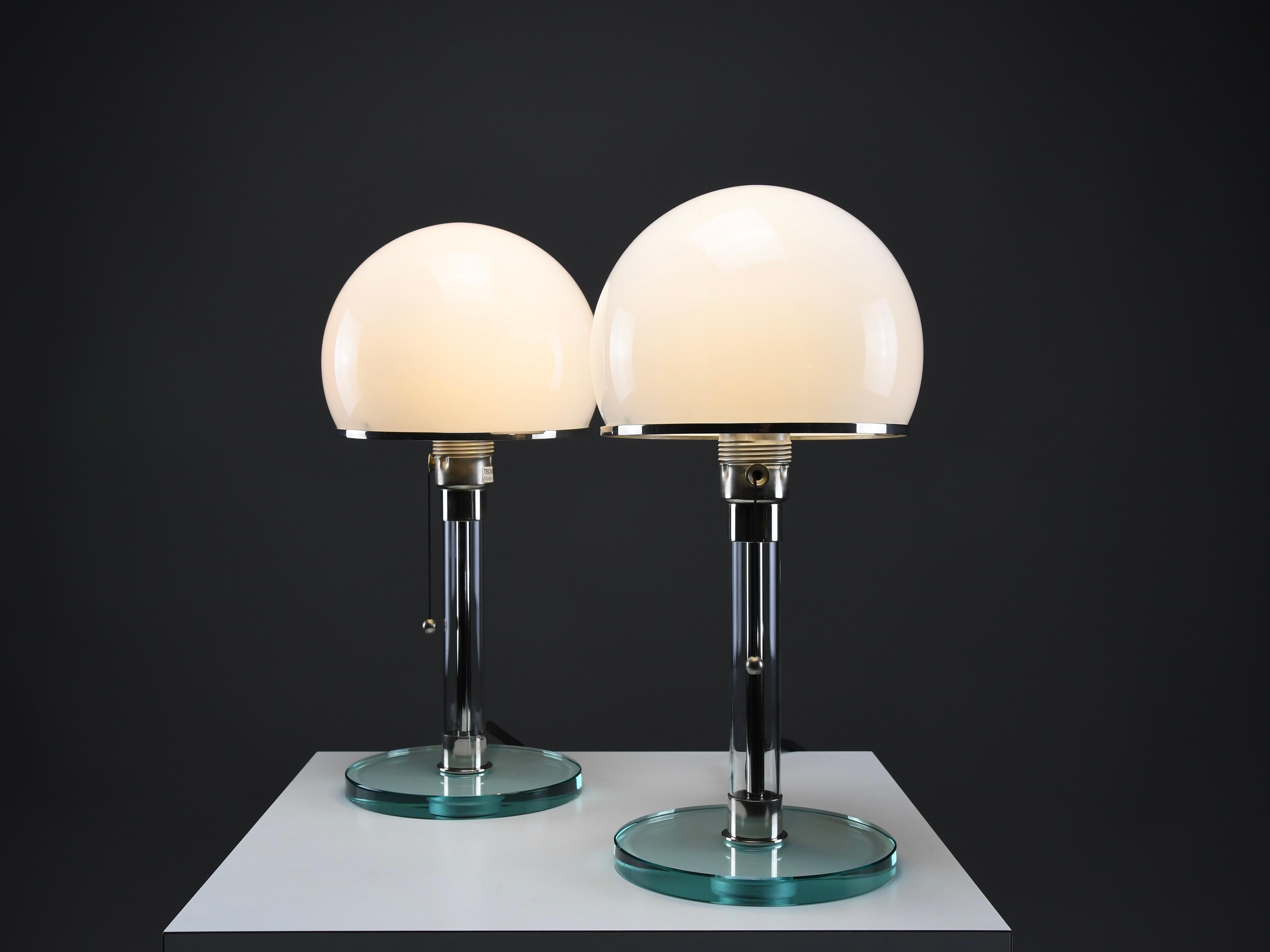 Iconic Pair of Bauhaus WG24 Table Lamps by Prof. Wilhelm Wagenfeld (Designed 1924)

Made by Tecnolumen, Germany – Numbered and Authenticated

Step into the essence of Bauhaus design with this rare and elegant pair of WG24 table lamps, conceived in