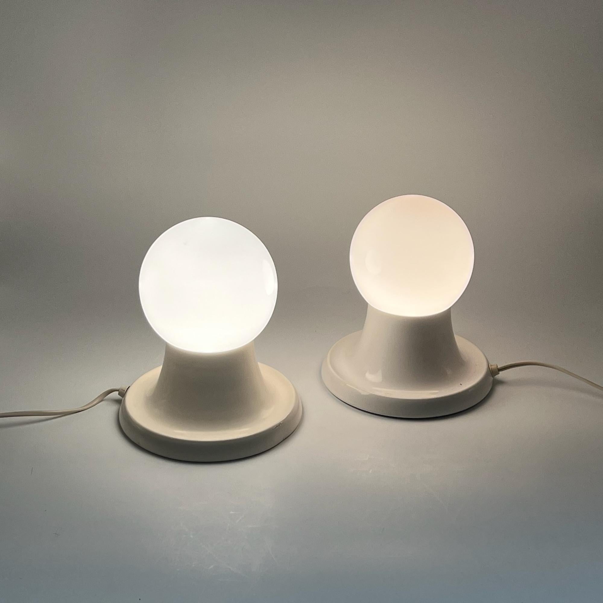 Iconic pair of 'Light Ball' table lamps - designed by Achille and Piergiacomo Castiglioni for Flos in 1961. White lacquered metal base with opaline glass bowl.
Iconic pair of ‘Light Ball’ table lamps – designed by Achille and Piergiacomo Castiglioni
