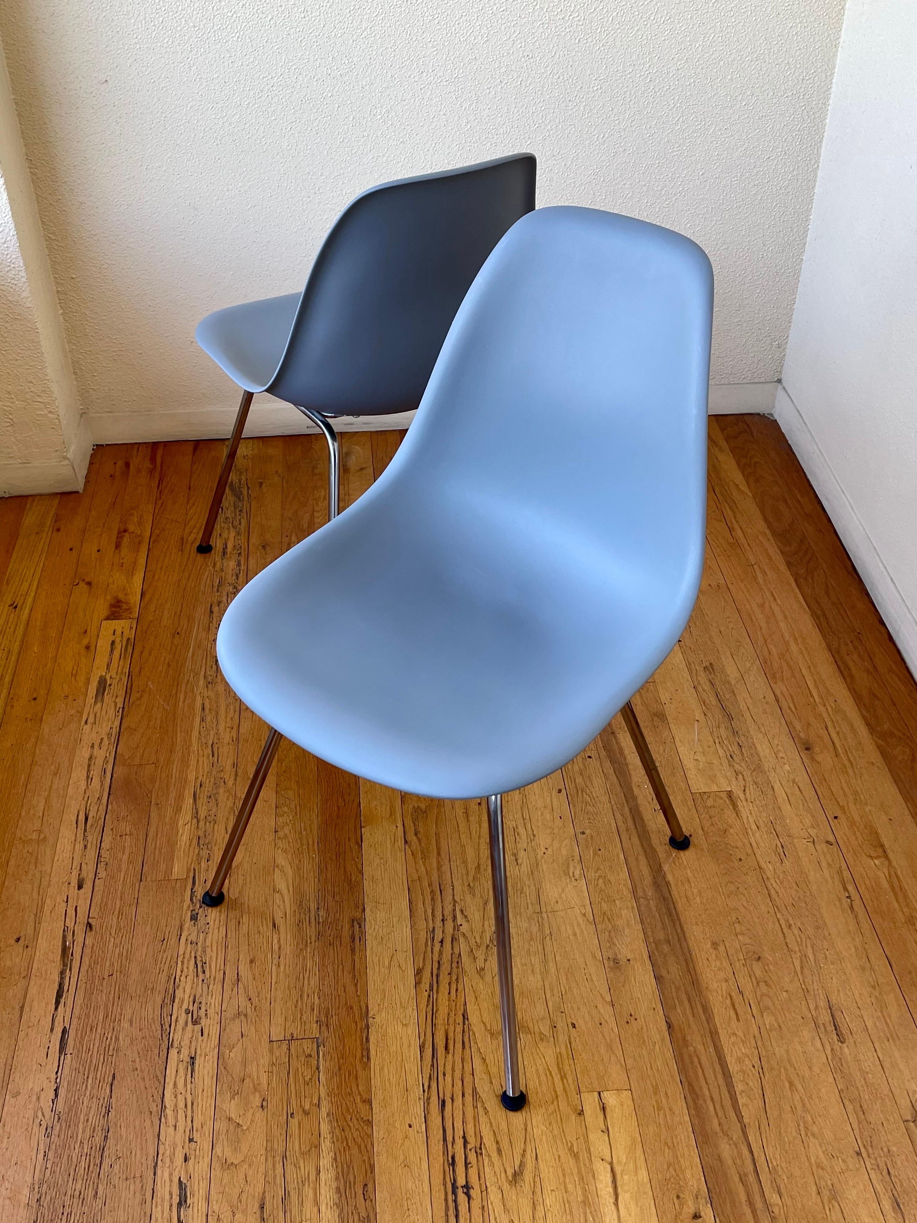 Great pair of molded plastic with chrome bases chairs designed by Eames for Herman Miller nice condition light wear. Produced in 2011, with a “Certificate of Authenticity” in Greystone color.