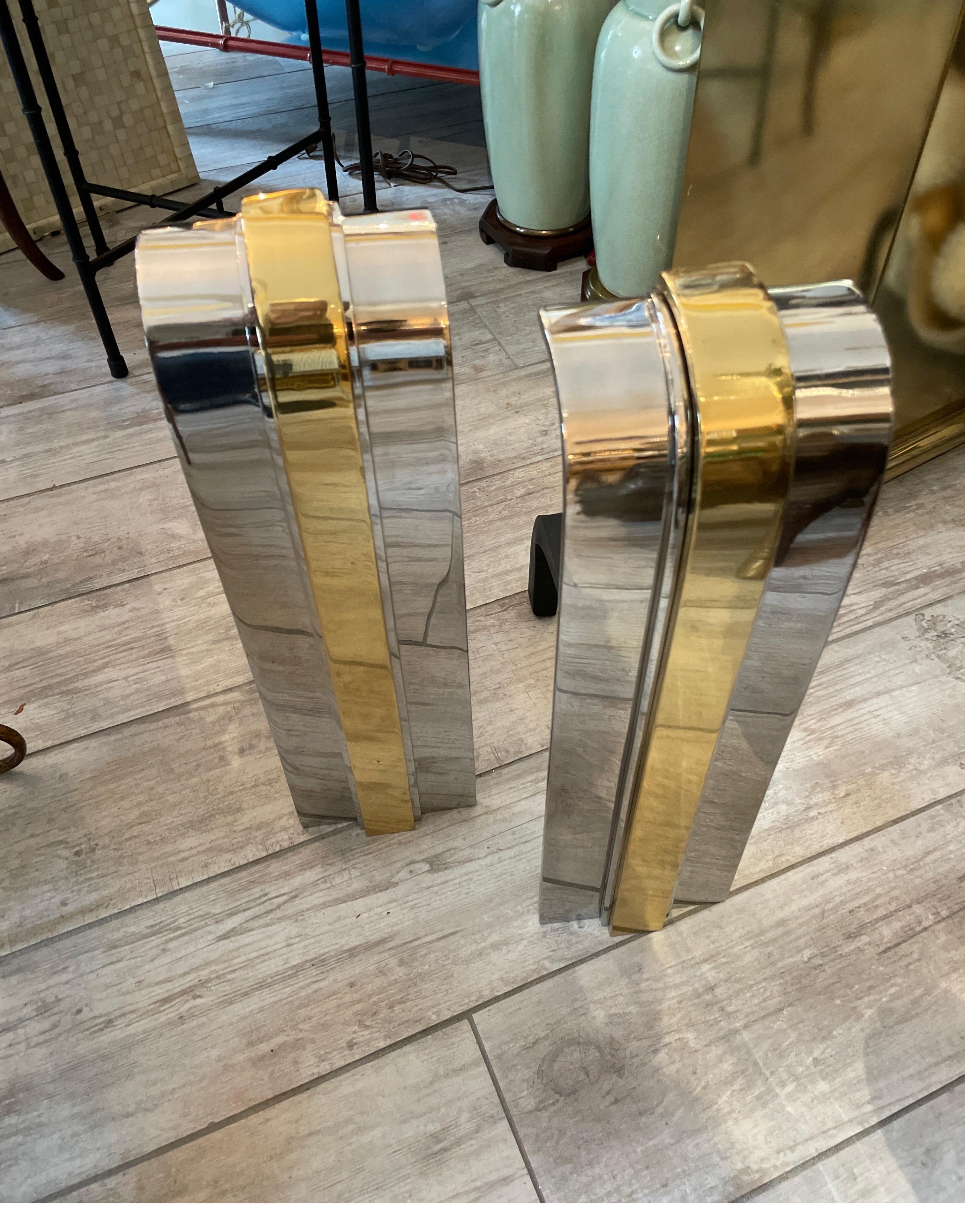 Iconic pair of Danny Alessandro modern Andirons in polished Chrome and Brass. A classical pair that makes a true statement.