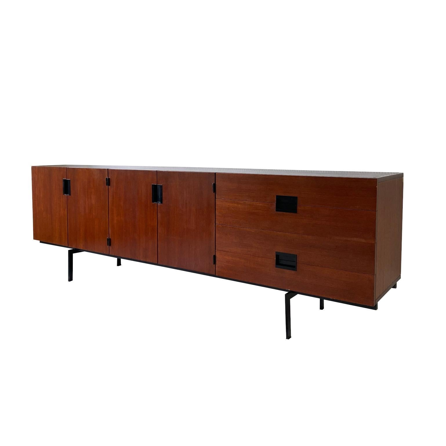 Mindblowing and timeless design, this large sideboard/Credenza by Cees Braakman for Pastoe, The Netherlands. This piece was made from teakwood veneer and features four drawers and two cabinets with a shelf each inside. This piece remains in very