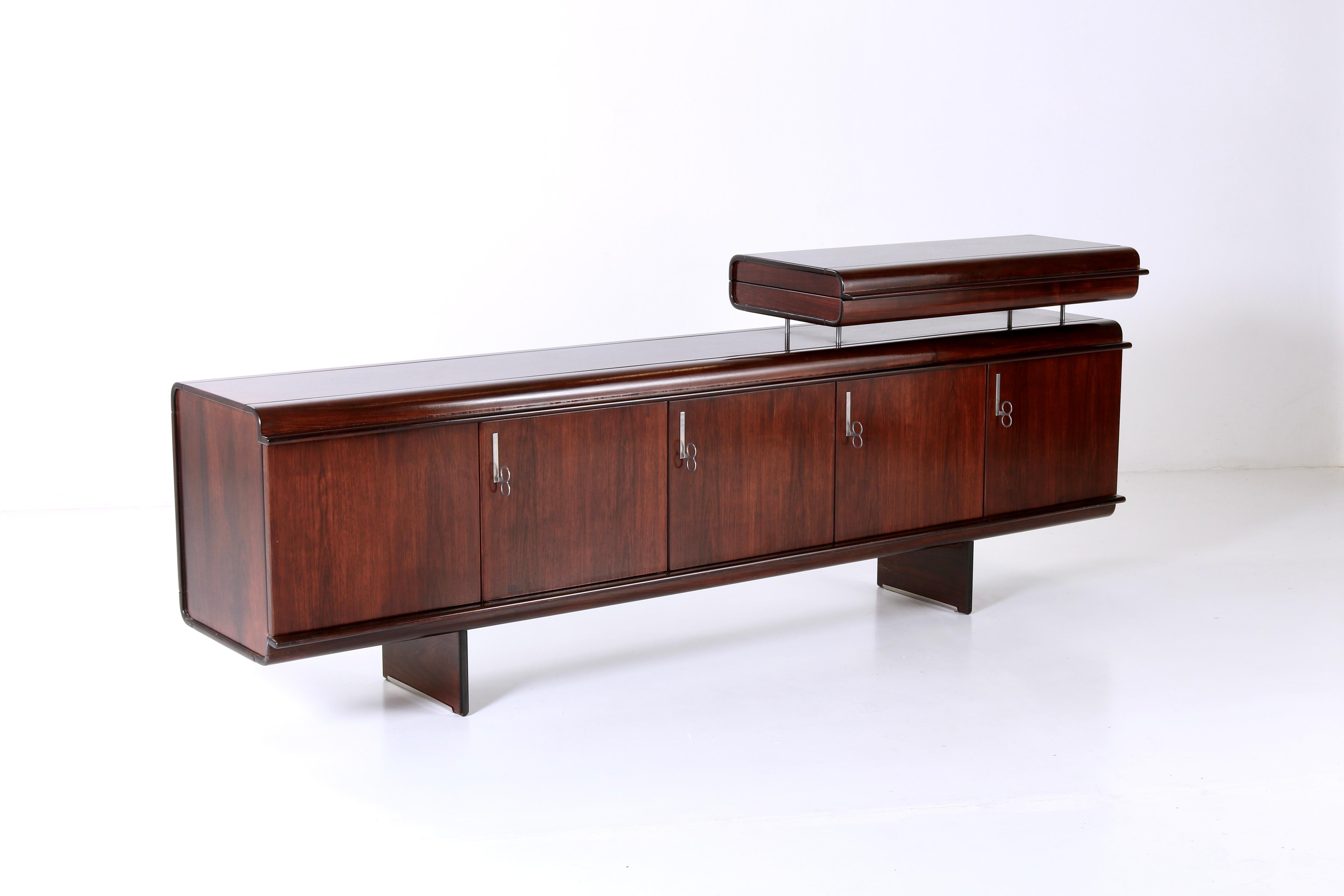 

The Pellicano sideboard by Vittorio Introini embodies elegance of mid-century Italian design. Crafted in wood with details in chrome-plated metal, its sleek lines and minimalist design exude timeless sophistication while offering considerable