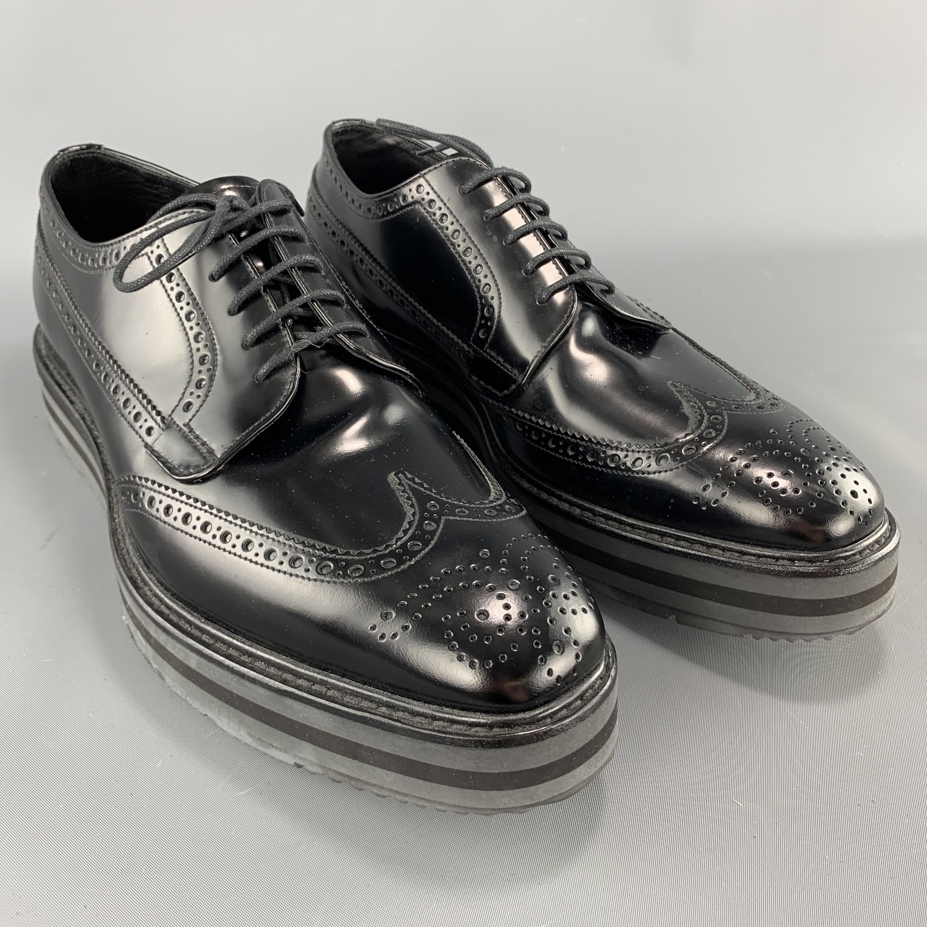 PRADA dress shoes come in smooth black leather with a wingtip toe, perforated brogueing  throughout, and striped platform rubber sole. Made in Italy.

Excellent Pre-Owned Condition.
Marked: UK 8

Outsole: 12.5 x 4.25 in.
Platform: 1.5 in.