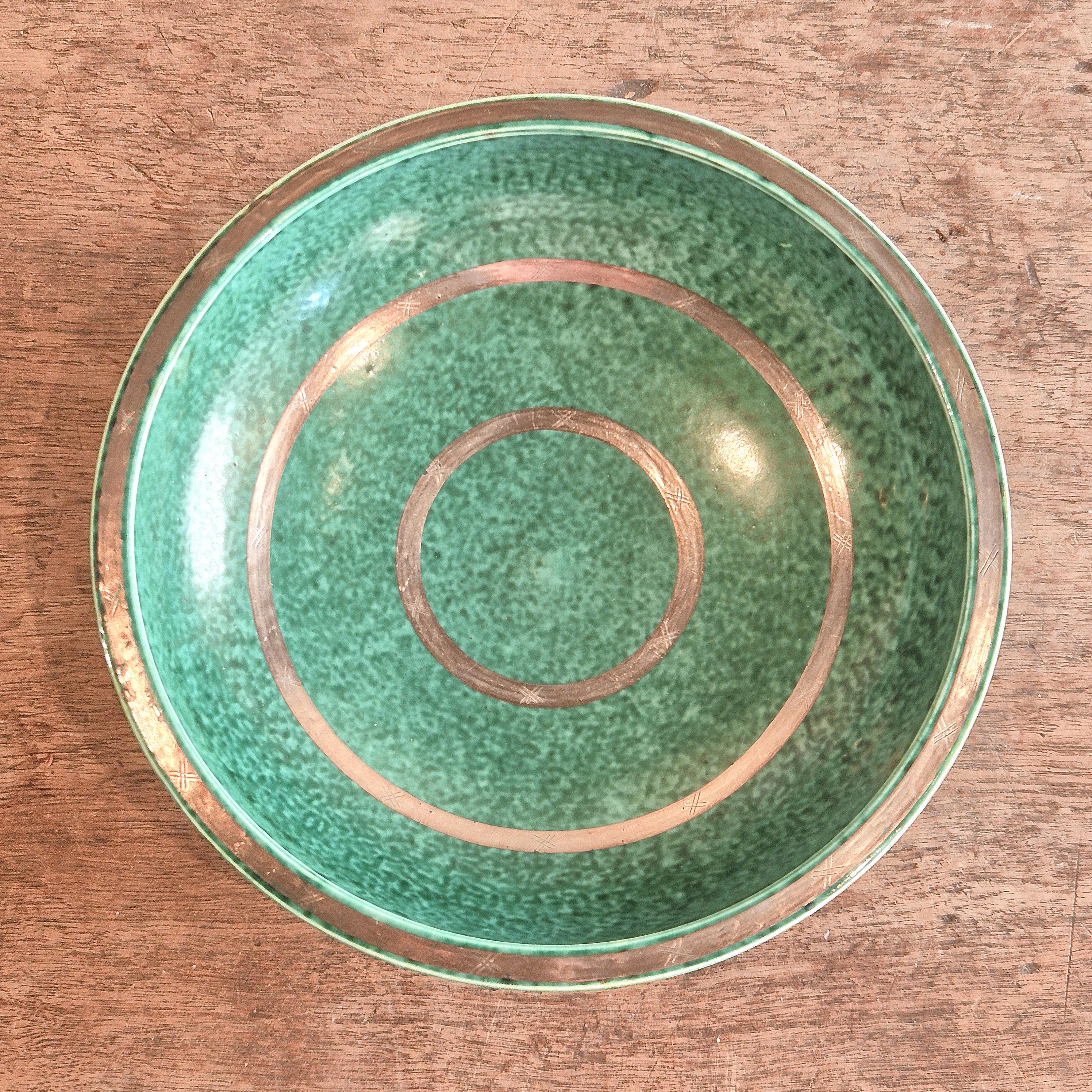 A Swedish modern classic, stoneware bowl in signature green glaze with decor of gemoterical / circle patterns. Designed by Wilhelm Kåge from the ‘Argenta’ series for Gustavsberg, Sweden. 

Signed in silver at the base as well as Embossed
