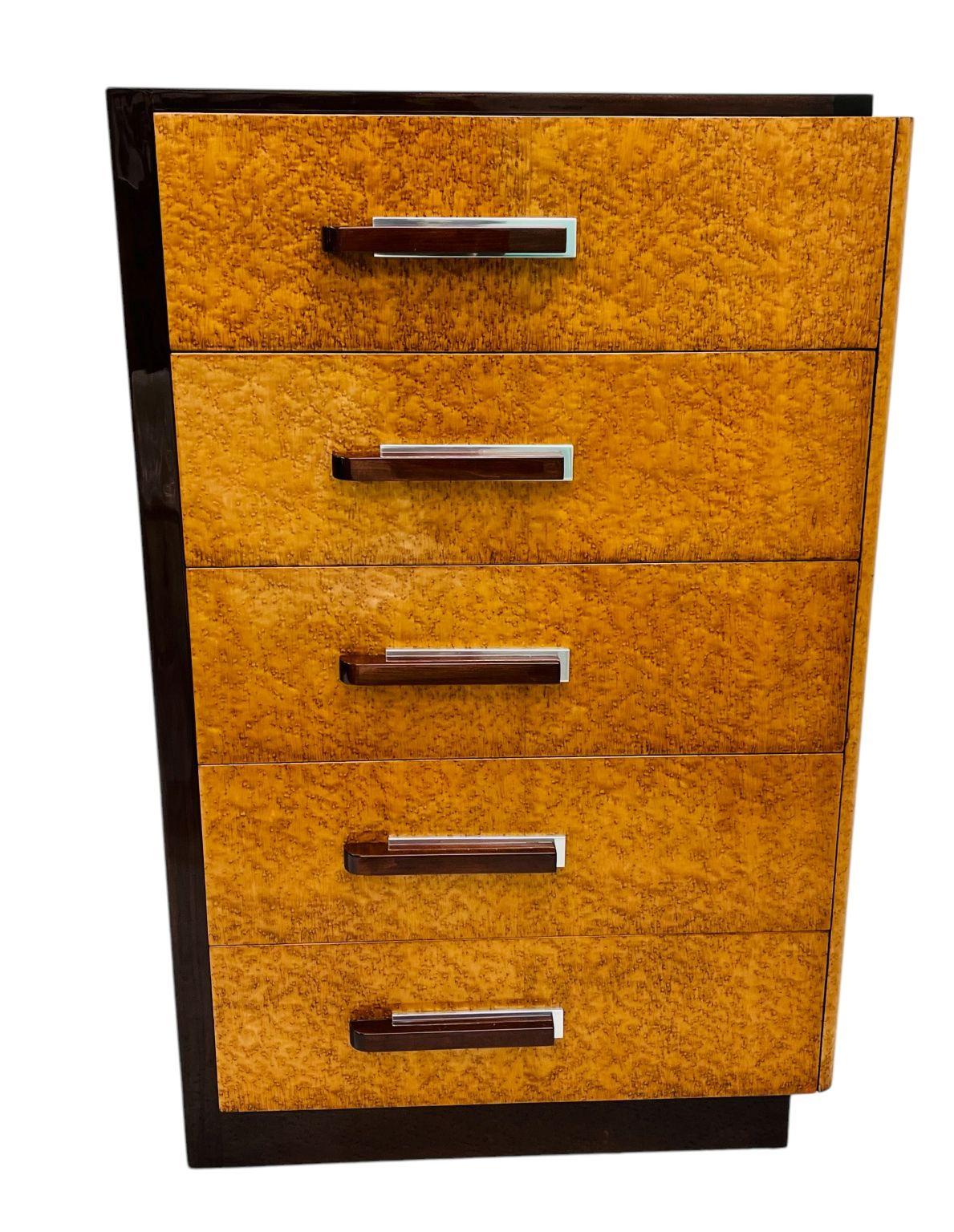  Beautiful and rare dresser designed by noteworthy art deco designer Donald Deskey for Widdicomb, circa 1935. This five-drawer chest is in excellent restored condition. Made of Birdseye Maple and maple-stained rosewood. The back plates of the