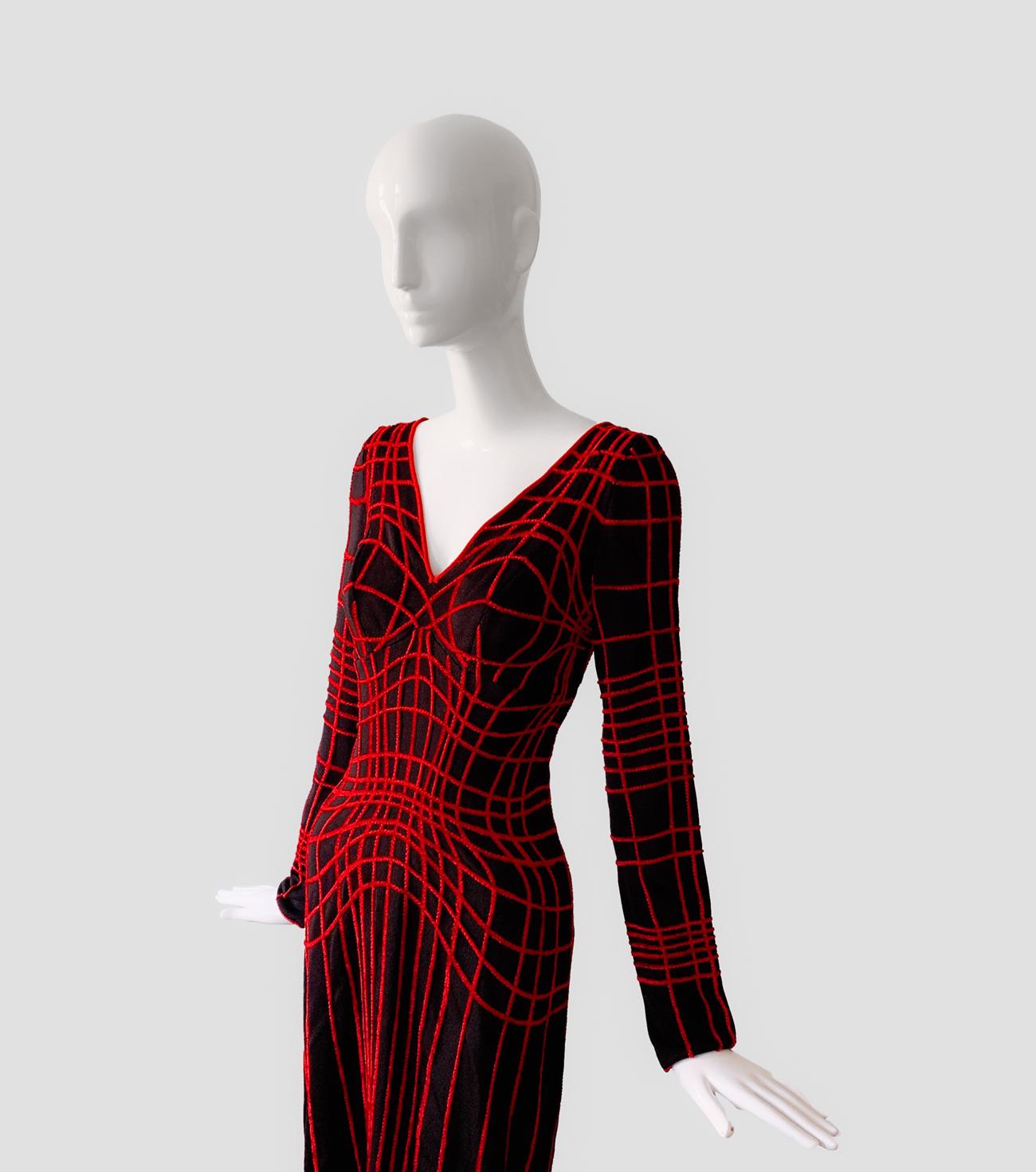 
Sensational Rare Museum Worthy Thierry Mugler Couture Dress, FW 2001 Collection.

Iconic Statement Piece

Amazing black bodycon dress fashioned of black viscose rayon with raised red velvet web lines to create dimensionality and 3D illusion.