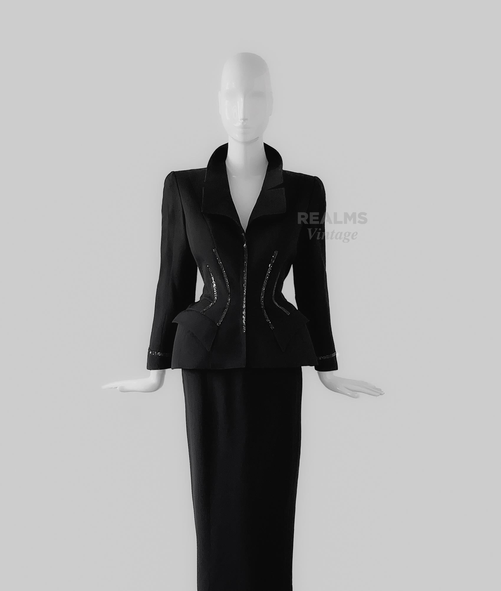 
The Iconic Thierry Mugler FW 1998 jacket famously captured by the legend Helmut Newton!
Extremely rare and documented piece, Museum Worthy. Black jacket and long black skirt ensemble.

Stunning fitted blazer jacket with crystal rhinestone details