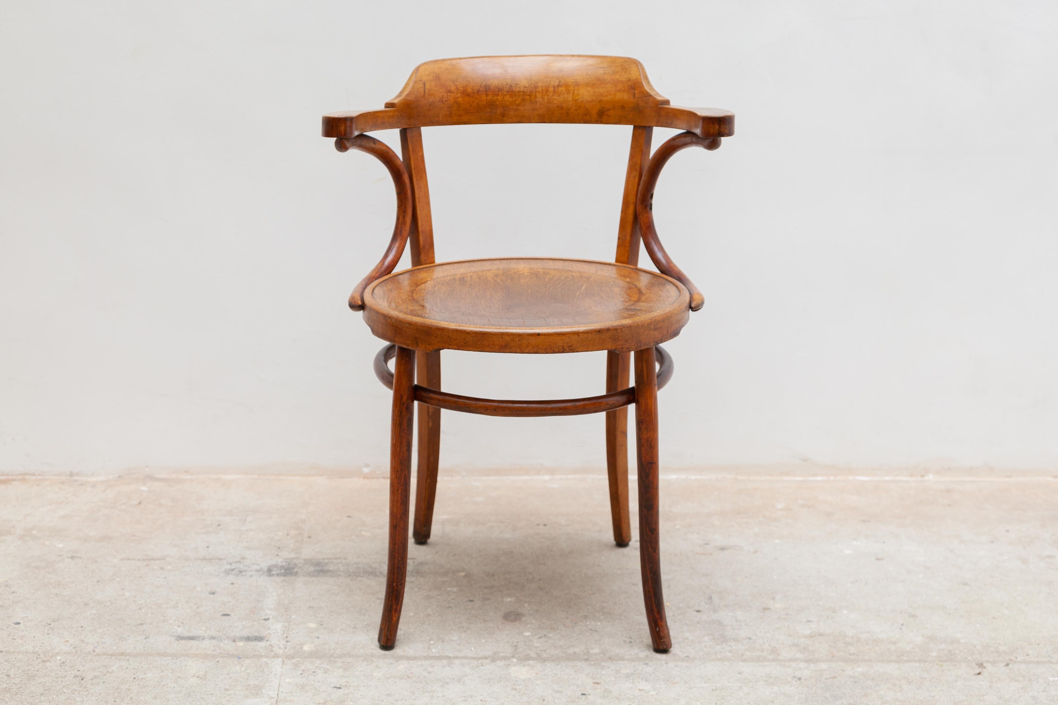 Iconic piece of bentwood open armchair. Manufactured in Austria by the Gebrüder Thonet Company. Steamed timber frame, impressed ply seat, unrestored original. The chair would be quite useful for desk chair or side chair.