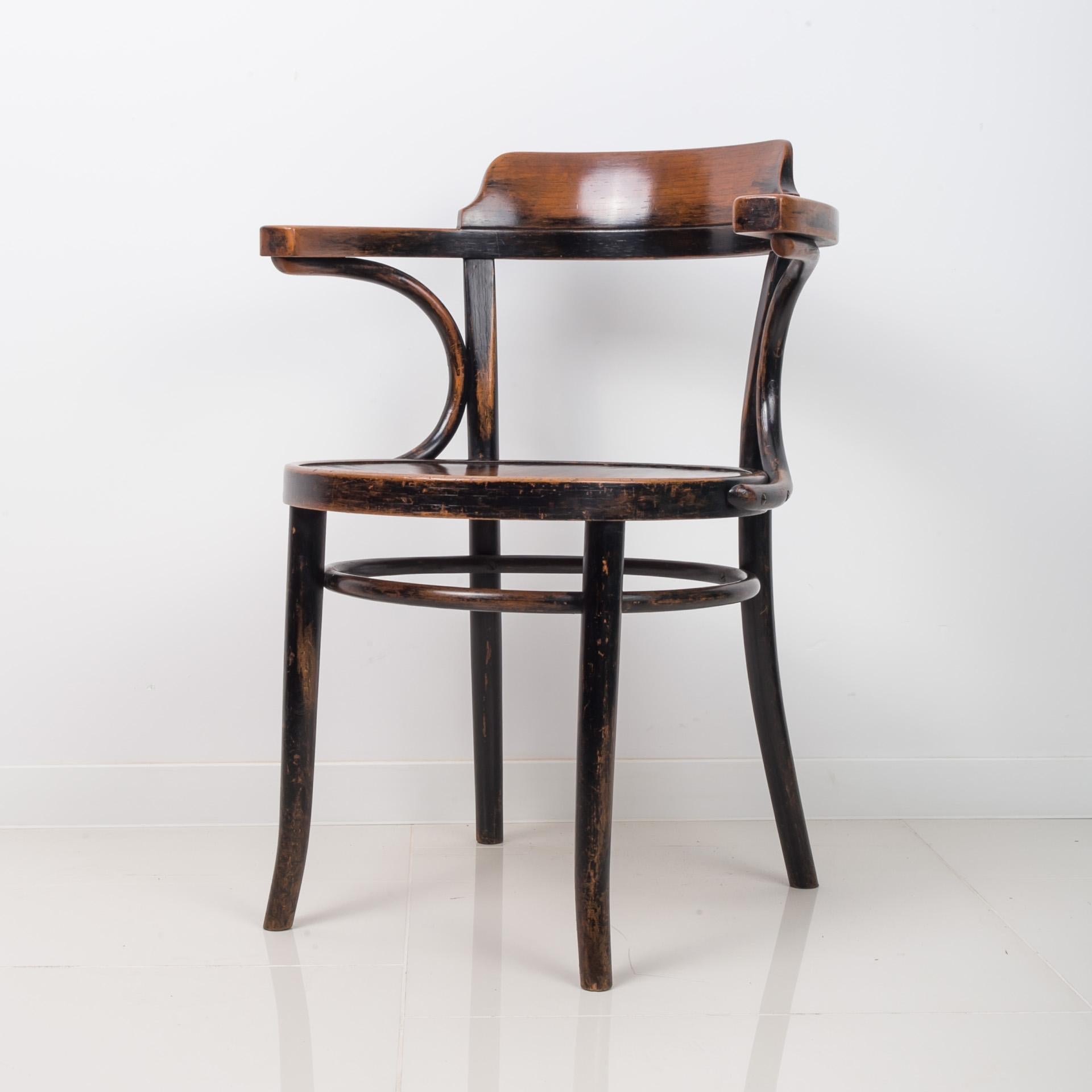 This chair with armrests dates back to the 1920s and was made by famous Thonet Company (original stamp preserved). The piece is made in famous Thonet technique - steamed bentwood. The piece is in beautiful original condition with nice patina, was