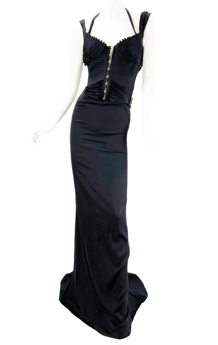 Iconic Tom Ford for Gucci Silk Stretch Black Corset Maxi Dress Gown
F/W 2003 Runway Collection
Italian size 38
This sexy dress features a corset top and cowl back with lots of strap and top-stitching details.
Adjustable metal buckles engraved with