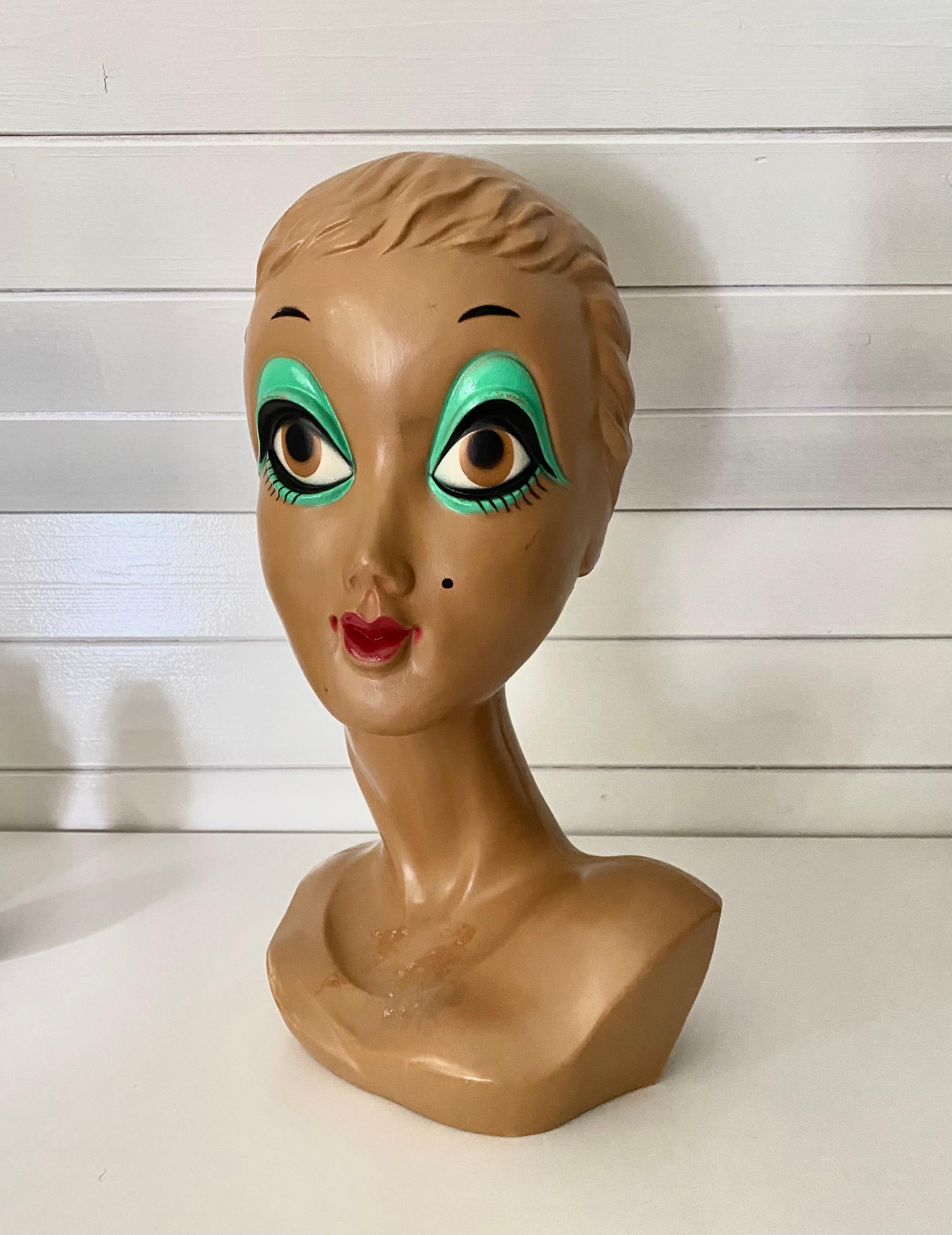 This Store Display or Mannequin Hat Stand was made from Plastic and features the English Mannequin Lesley Lawson, Also known as Twiggy because of her very thin figure. This piece remains in good condition with some wear to it's base (see: images).