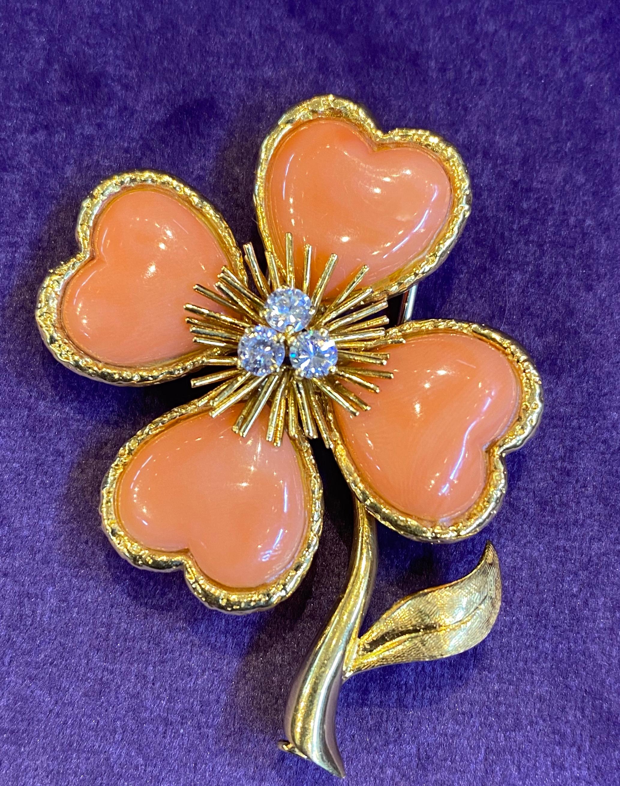 Van Cleef & Arpels Coral & Diamond Clover Flower Brooch 
3 round cut diamonds
Measurements: 2” long 
Signed Van Cleef & Arpels and serial numbered
Gold Type: 18K Yellow Gold
