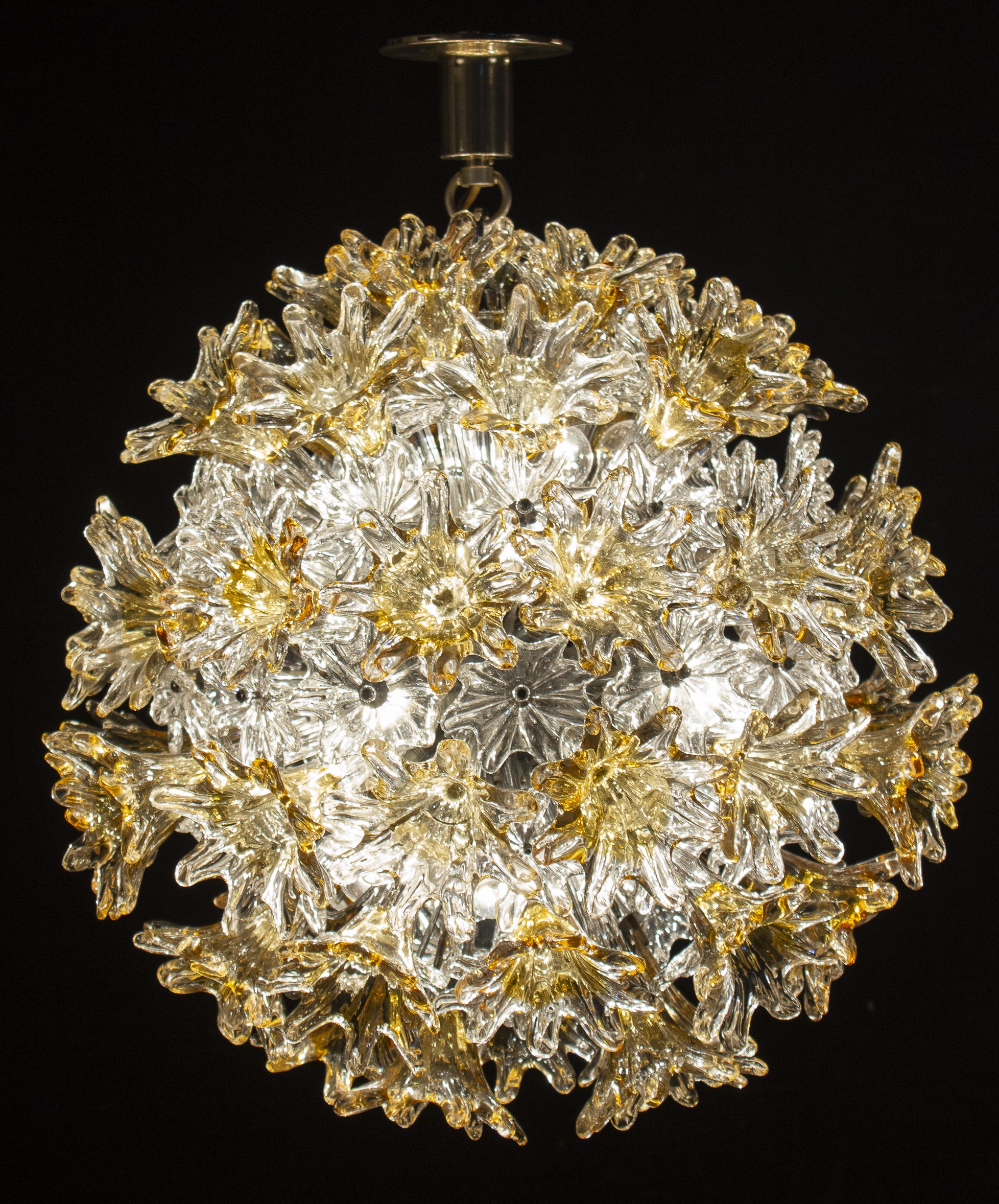 This striking esprit chandelier was produced by Venini during the 1970s.
Explosion of flowers, made with amber and clear precious Murano glasses.
Chrome frame and hardware. Available also the chain on request.
Perfect vintage condition.