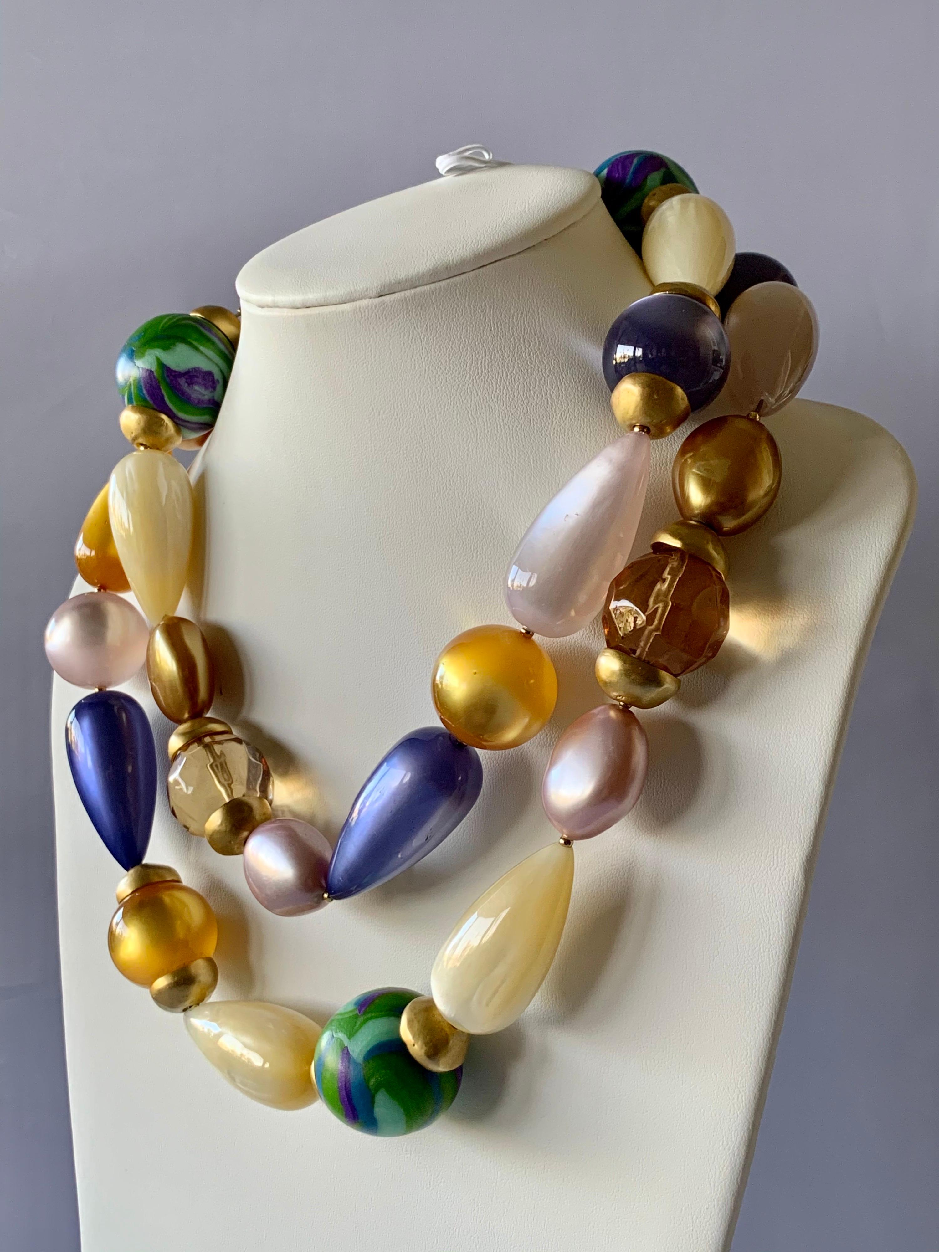 Iconic massive vintage Coco Chanel runway beaded statement necklace, comprised out of large architectural acrylic beads. The beads vary in shape, size, and color (taupe, Moonglow blue, pale pink, gold, and swirled green and accented by large faceted