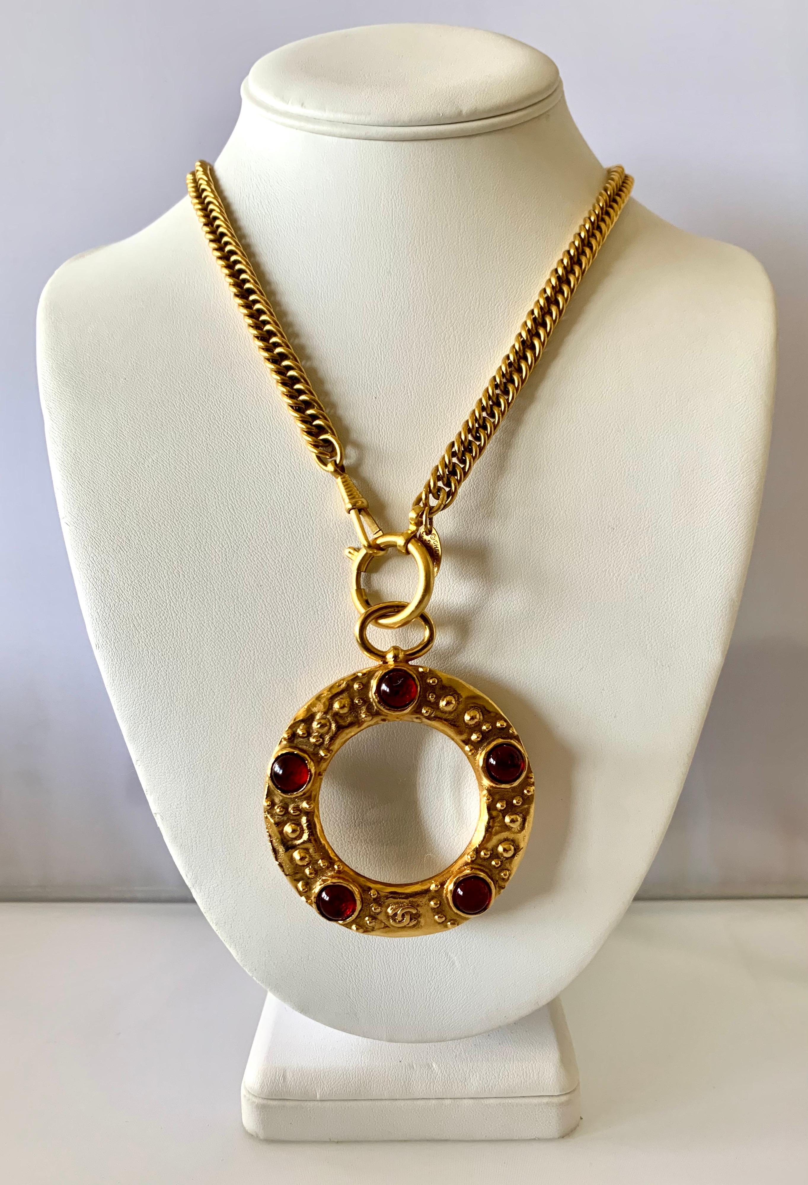 Iconic vintage Coco Chanel gilt metal magnifying glass pendant necklace with red 