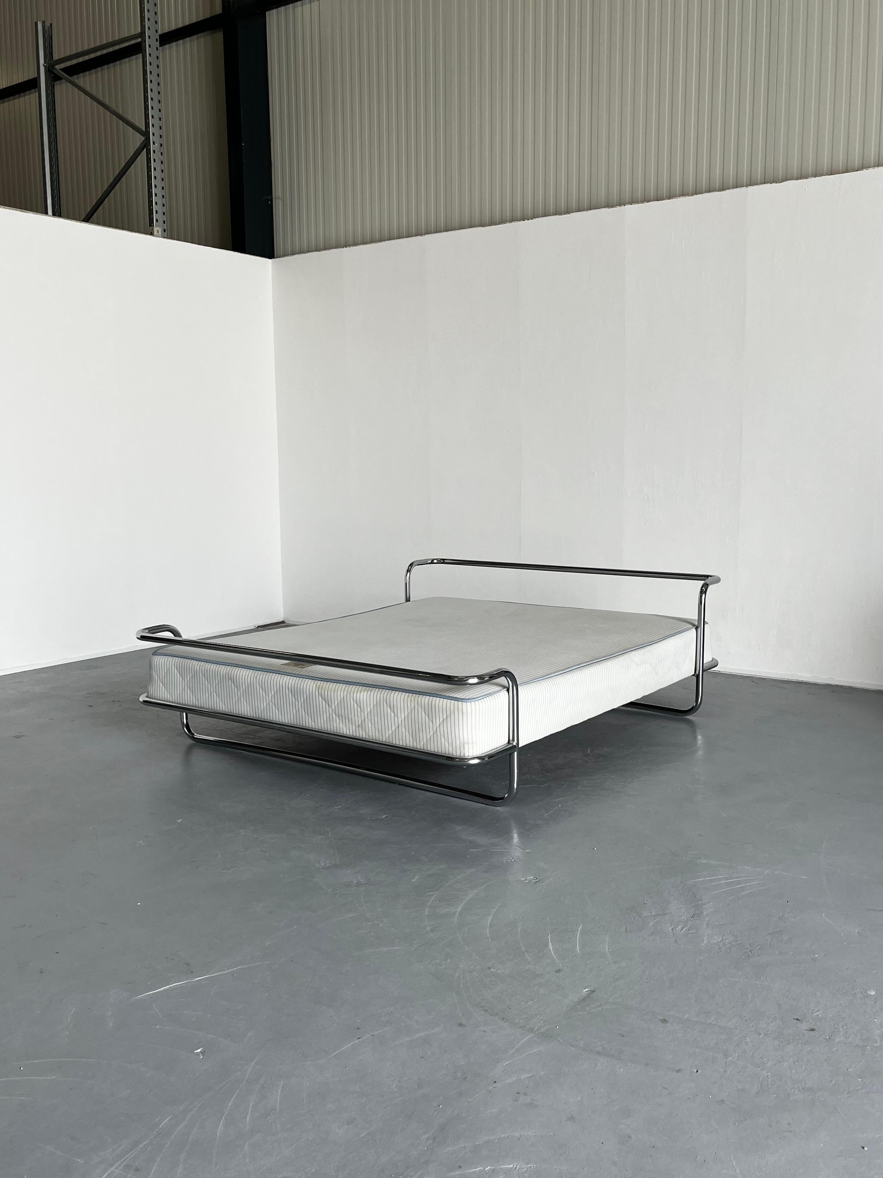 The iconic and rare vintage Ikea KROMVIK chrome king-size bed with the original SULTAN sprung mattress, designed by Knut Hagberg, 1982.

The modernist form takes clear inspiration from Swedish architect Bruno Mathsson’s 1974 Ulla bed. Designed to