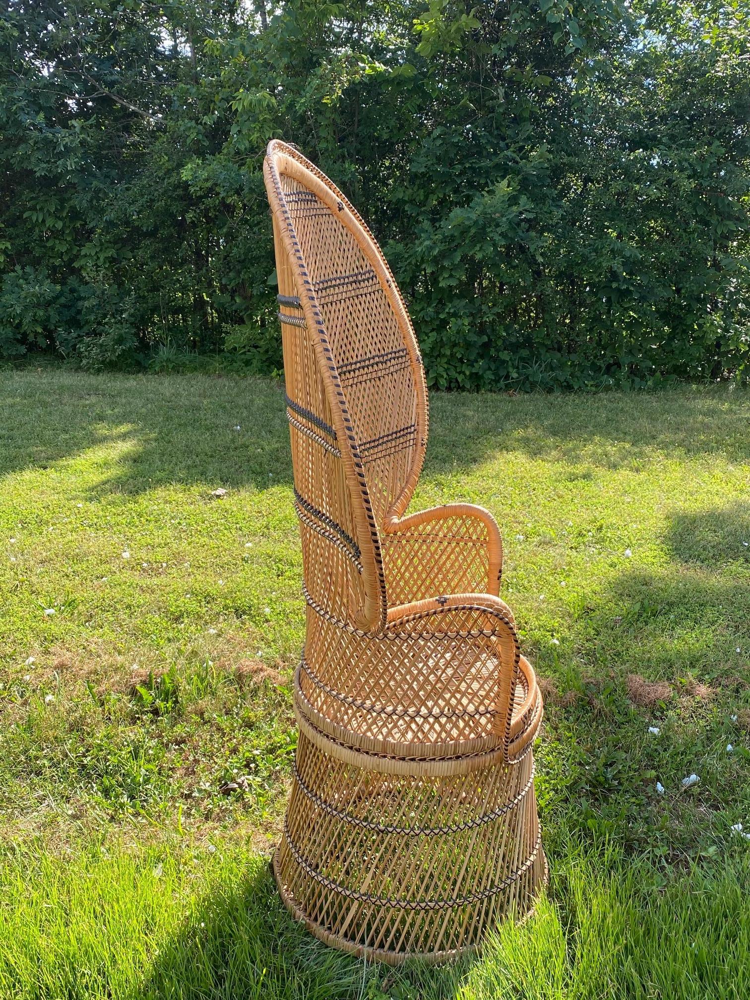 A fabulously shaped peacock chair of wicker and woven rattan from the 1970s.
Measures: Arm height 31.5.