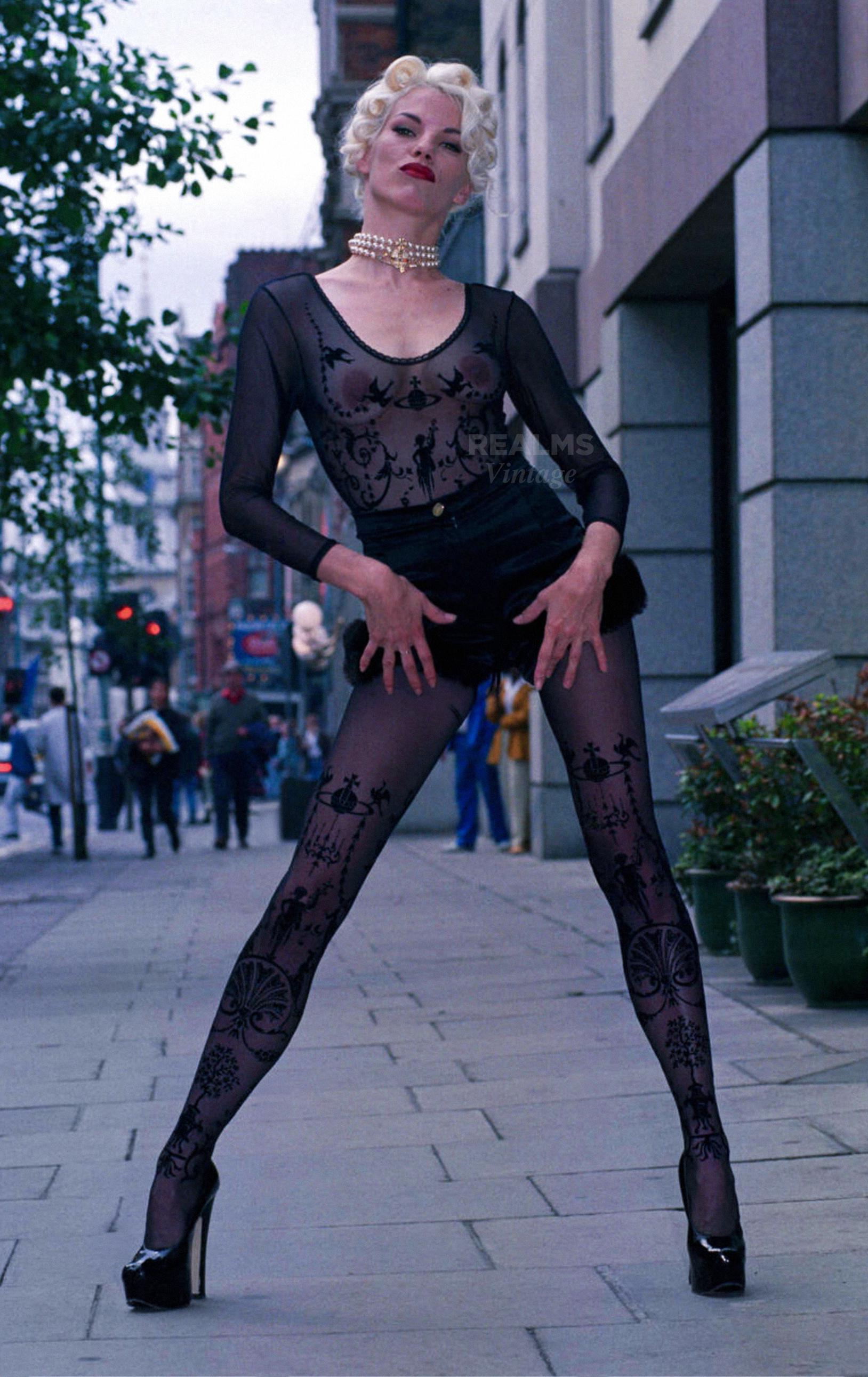 
The stunning 1992 Vivienne Westwood Boulle bodysuit. Iconic Vivienne Westwood Collectors Piece.
Sexy semi sheer black bodysuit featuring the iconic Boulle print.  The material is soft and stretchy formfitting. 
marked size medium