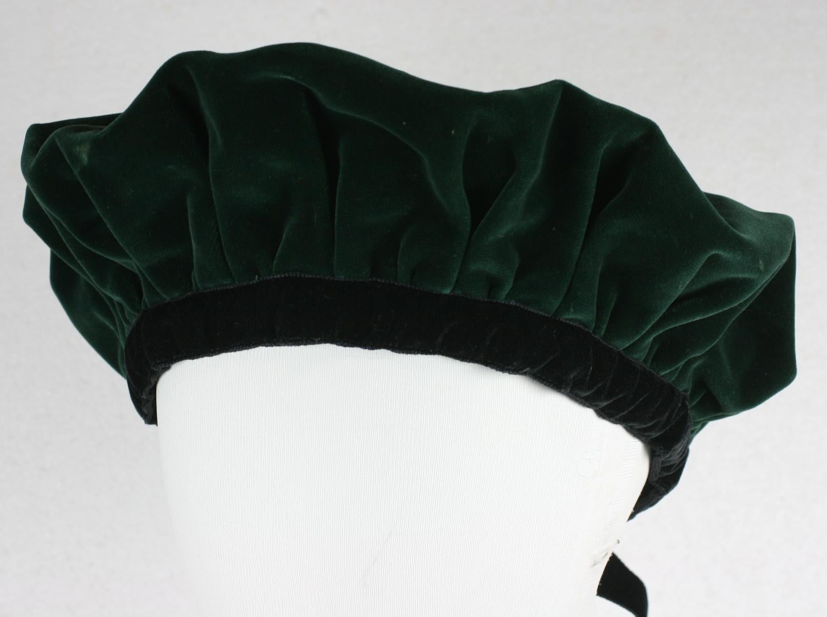 Iconic Yves Saint Laurent Deep Green Cotton Velvet Rive Gauche Beret from the 1980's. Edged and tied in black grosgrain ribbon. YSL Rive Gauche. 1980's France. 
Interior Band measures 22