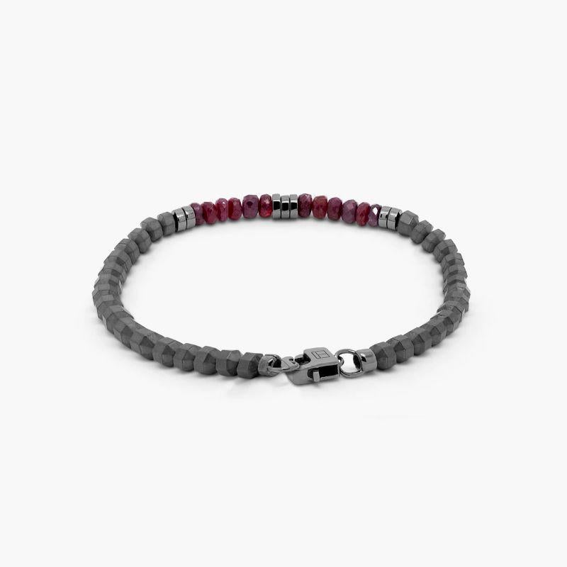 Icosahedron Ruby Bracelet in Hematite with Sterling Silver, Size L

Faceted ruby stones sit together with accents of black rhodium-plated sterling silver discs and finished with our lobster clasp. Hematite stones are cut into a 20 sided shape,