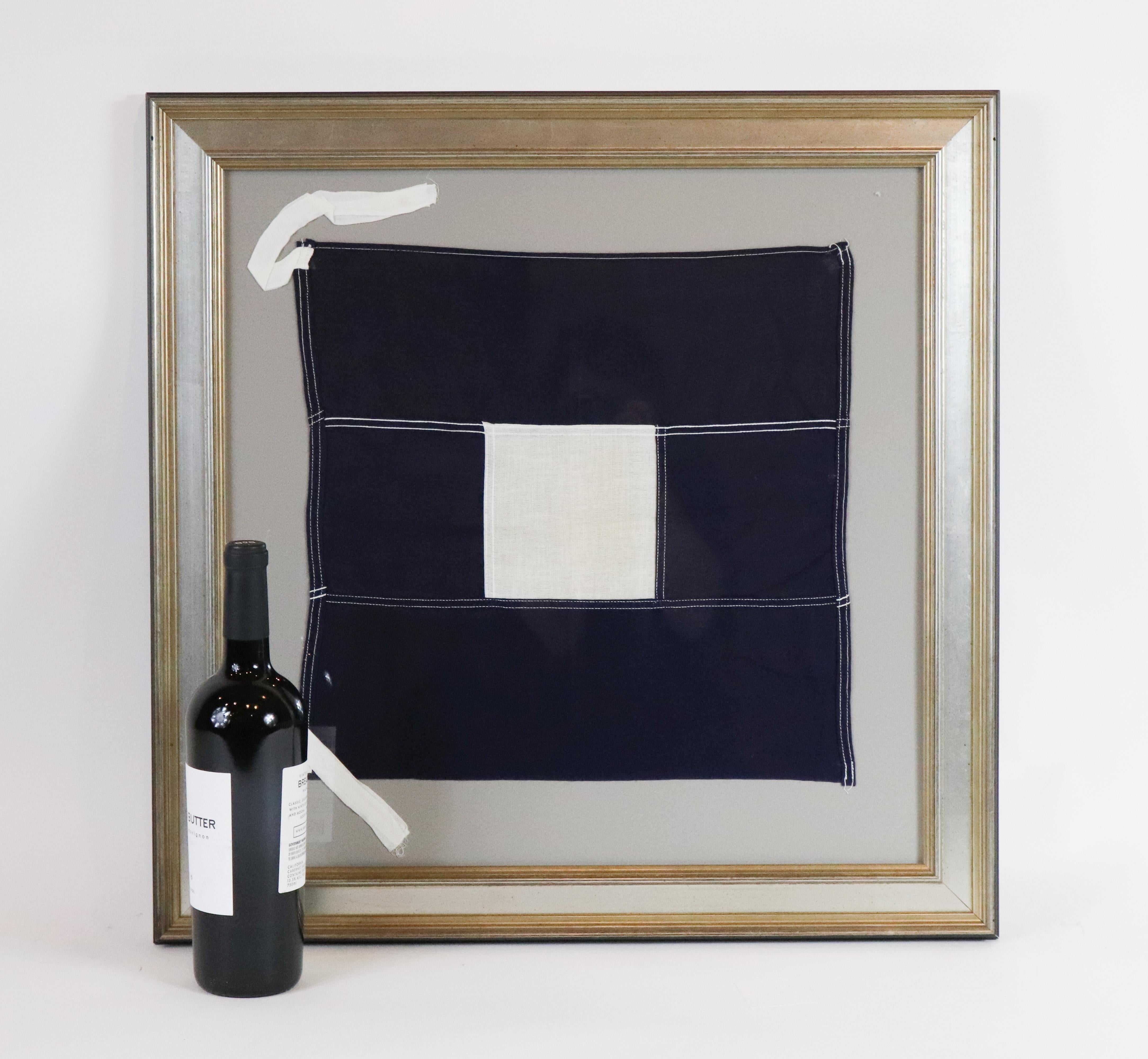 Framed nautical flag. International code of signals for the letter P, otherwise known as The Blue Peter sharing two meanings:

In harbour: All persons should report on board as the vessel is about to proceed to sea.

At sea: It may be used by