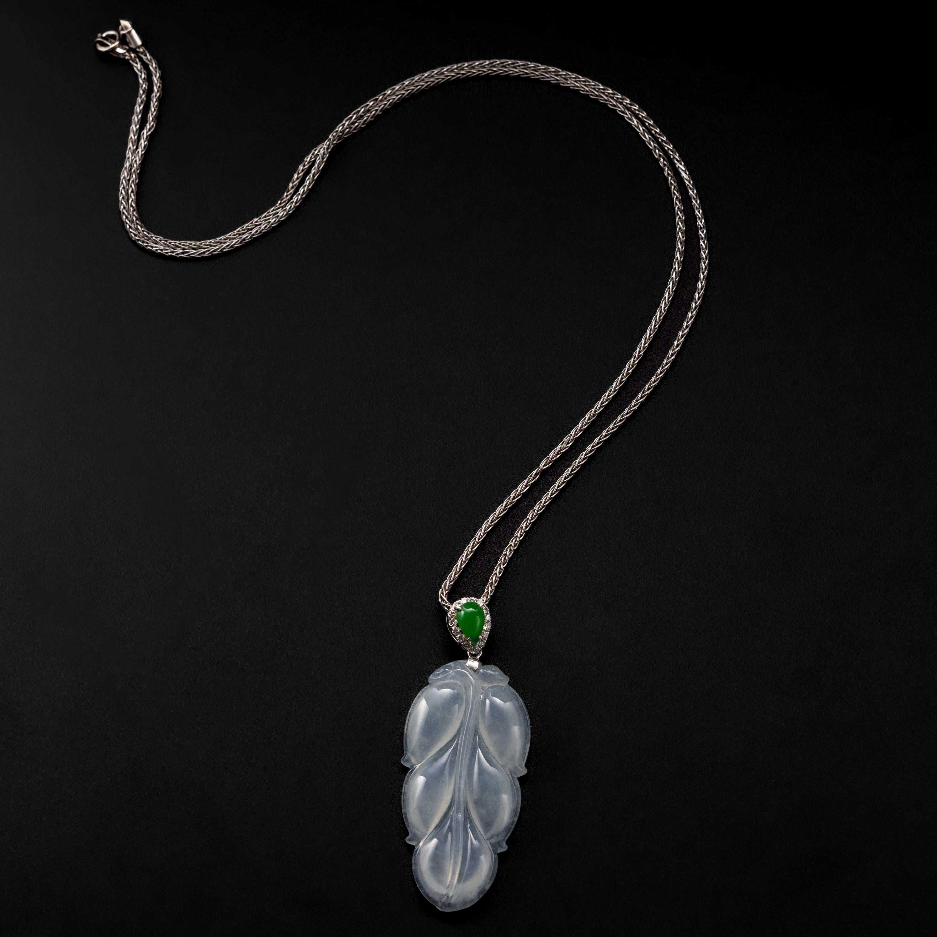 This near-colorless and semi-translucent hand-carved leaf pendant was created in the 1980s from 