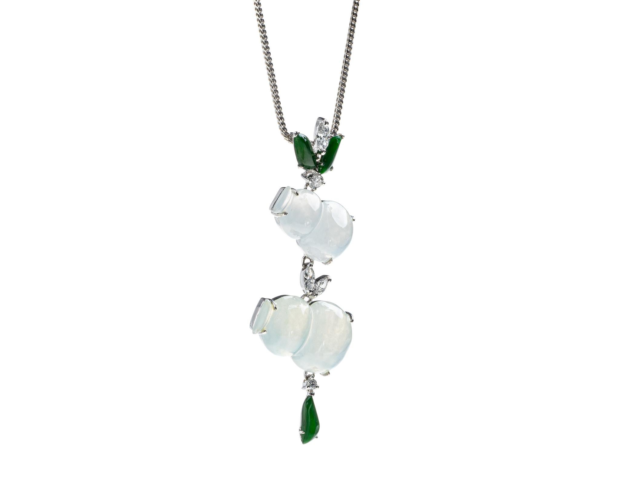 This is an all natural, untreated jadeite jade carved gourd and diamond pendant set on an 18K white gold and diamond bail.  The carved gourd symbolizes protection, great health and longevity.   

It measures 1.99 inches (50.7 mm) x 0.69 inches (17.5