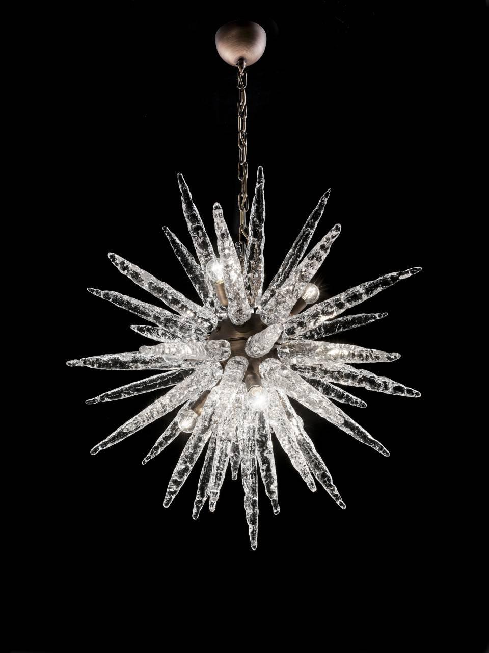 Italian Sputnik chandelier with clear Murano icicle shaped glasses, mounted on bronze metal finish frame / Designed by Fabio Bergomi for Fabio Ltd / Made in Italy
9 lights / E12 or E14 type / max 40W each
Height: 30 inches plus chain and canopy /