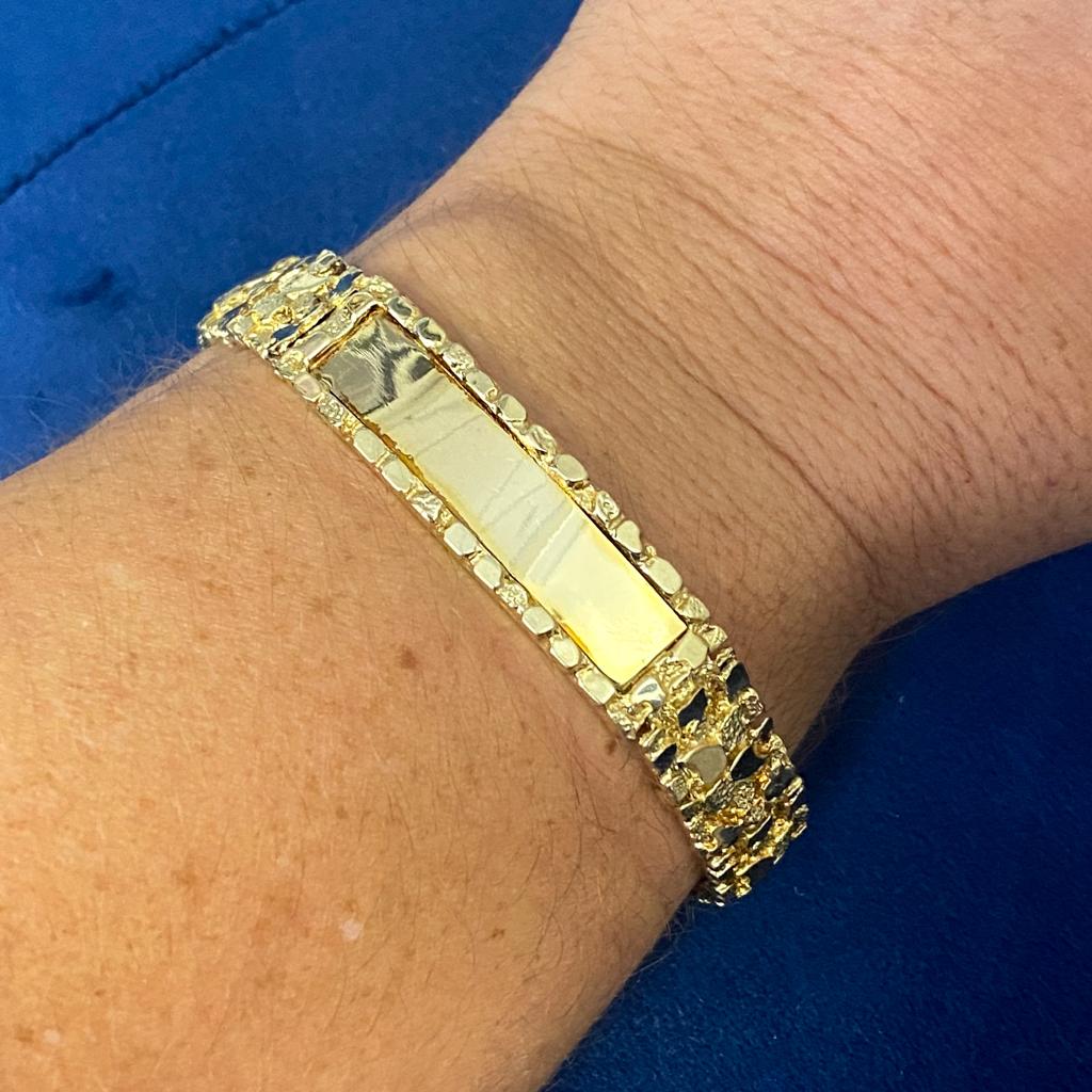 This ID bracelet is versatile thanks to the organic gold nugget pattern on the nearly 0.5-inch wide bracelet. It is comfortably low profile in a solid and sturdy link style. The curved gold polished plate center is 1.5 inches long and perfect for
