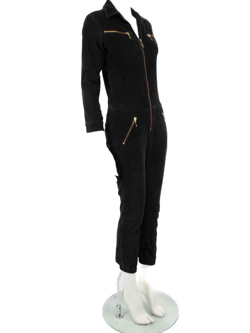 CONDITION is Good. Minor wear to the jumpsuit is evident. Light wear to the fabric surface which has a general washed appearance as well as a handful of small discoloured marks through the centre front and inside the collar on this used Ida designer