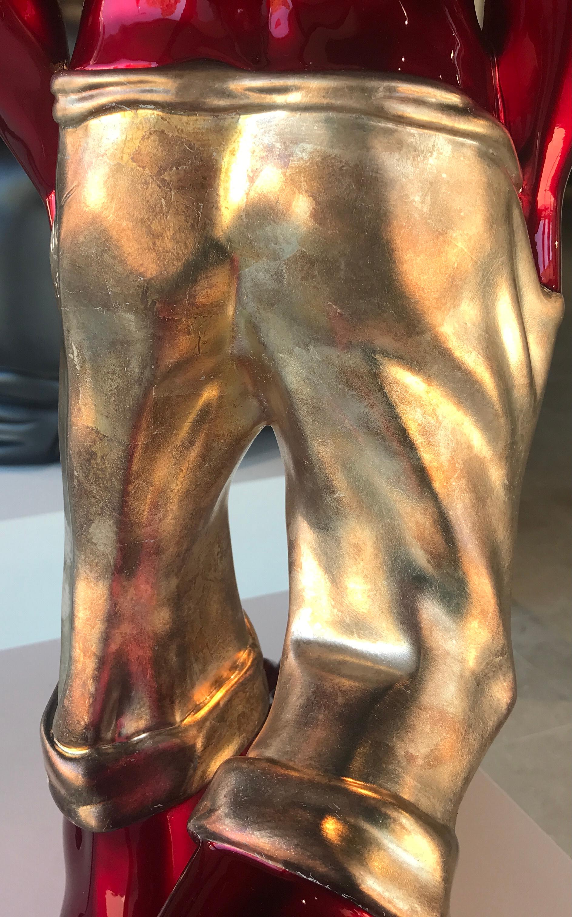 red bowing man sculpture
