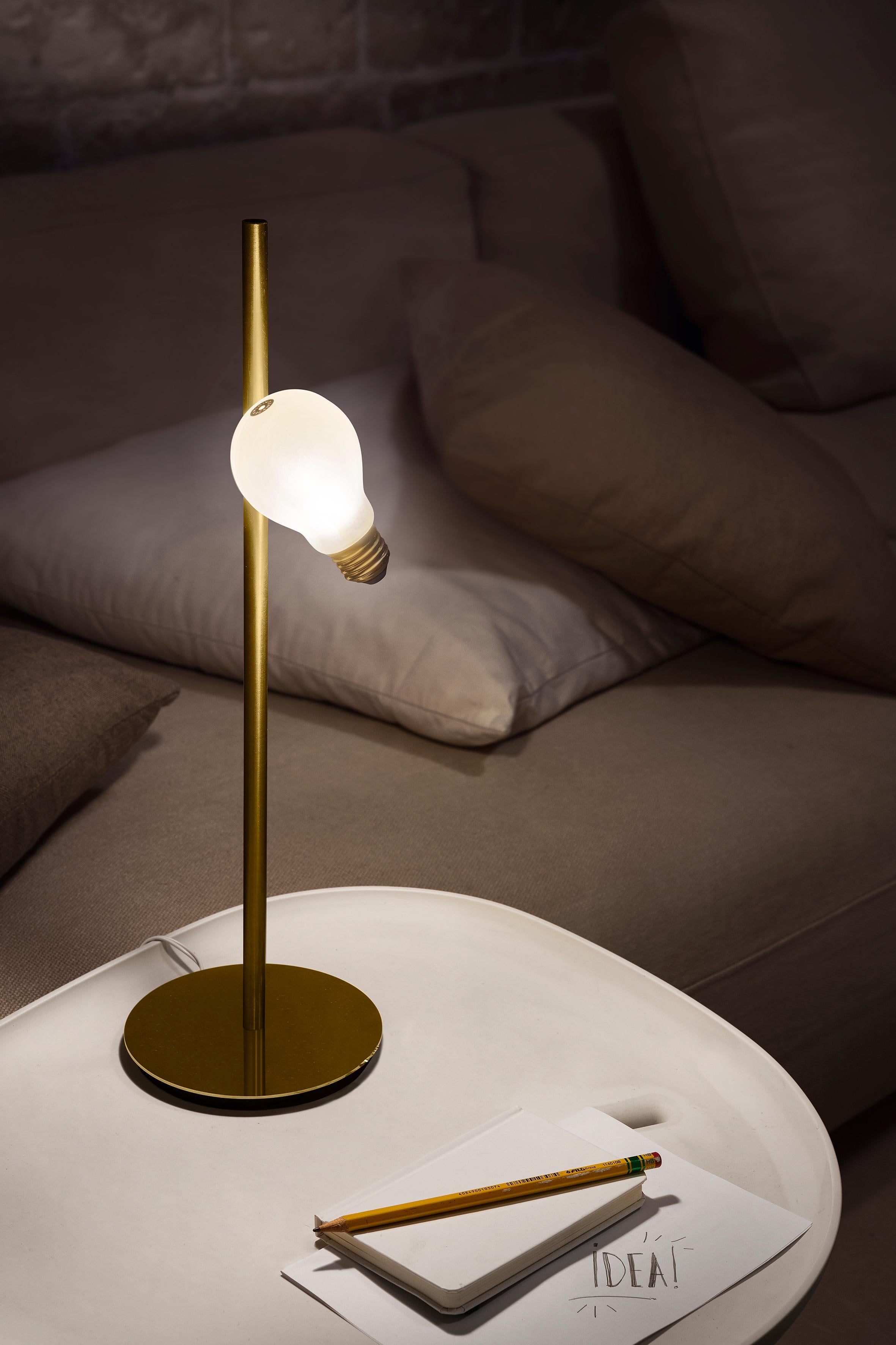 They say inspiration comes on like a lightbulb going off in your head. Idea strips away design, leaving the essence of light; a three-dimensional “bulb” and a brass-finish screw base, magically suspended on a wall-base that comes in a brushed brass,