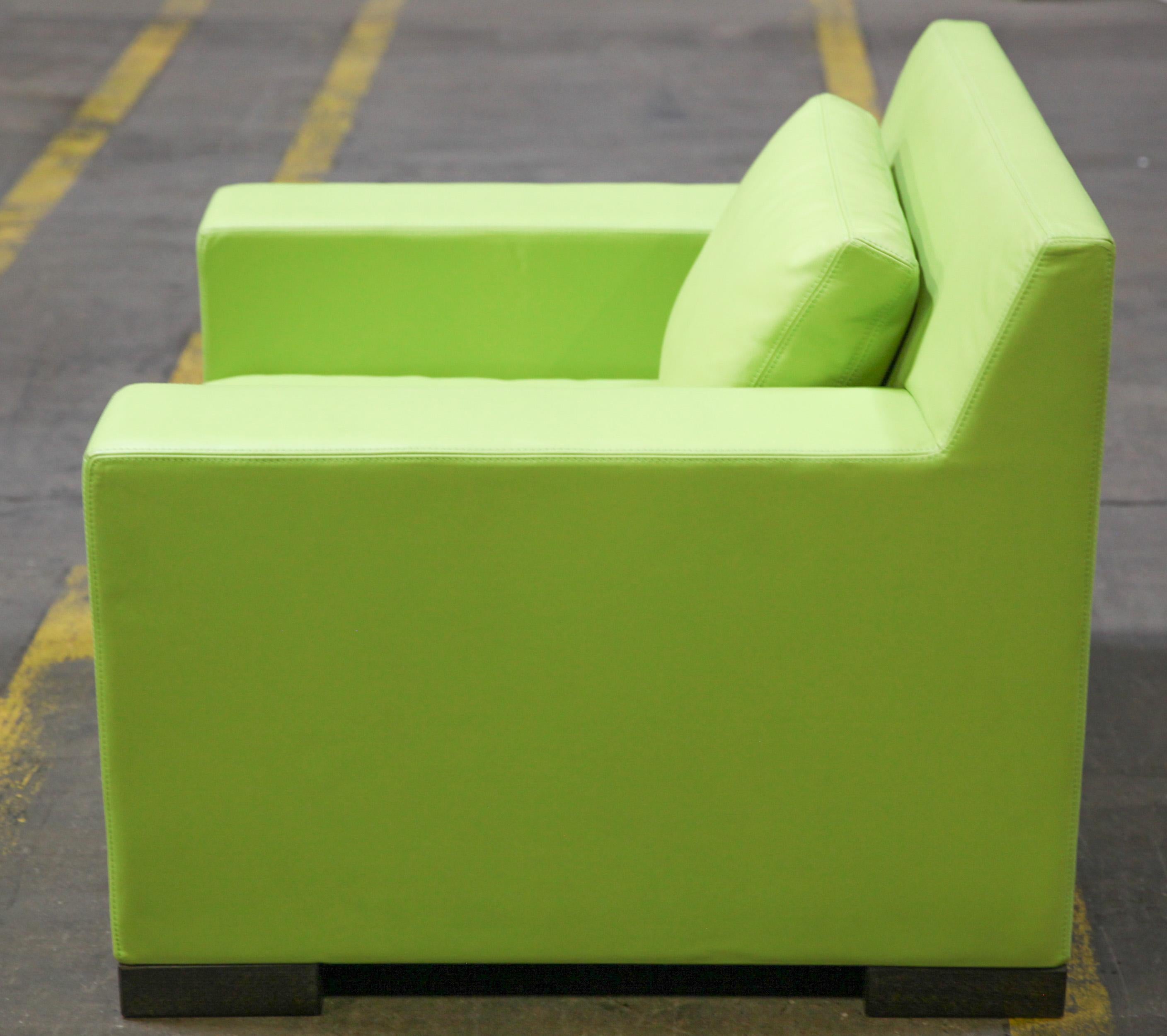 Modern club chair in green leather upholstery and cushion, made by Ideo. The piece has a makers label underneath the seat cushion and is in great vintage condition with age-appropriate wear.