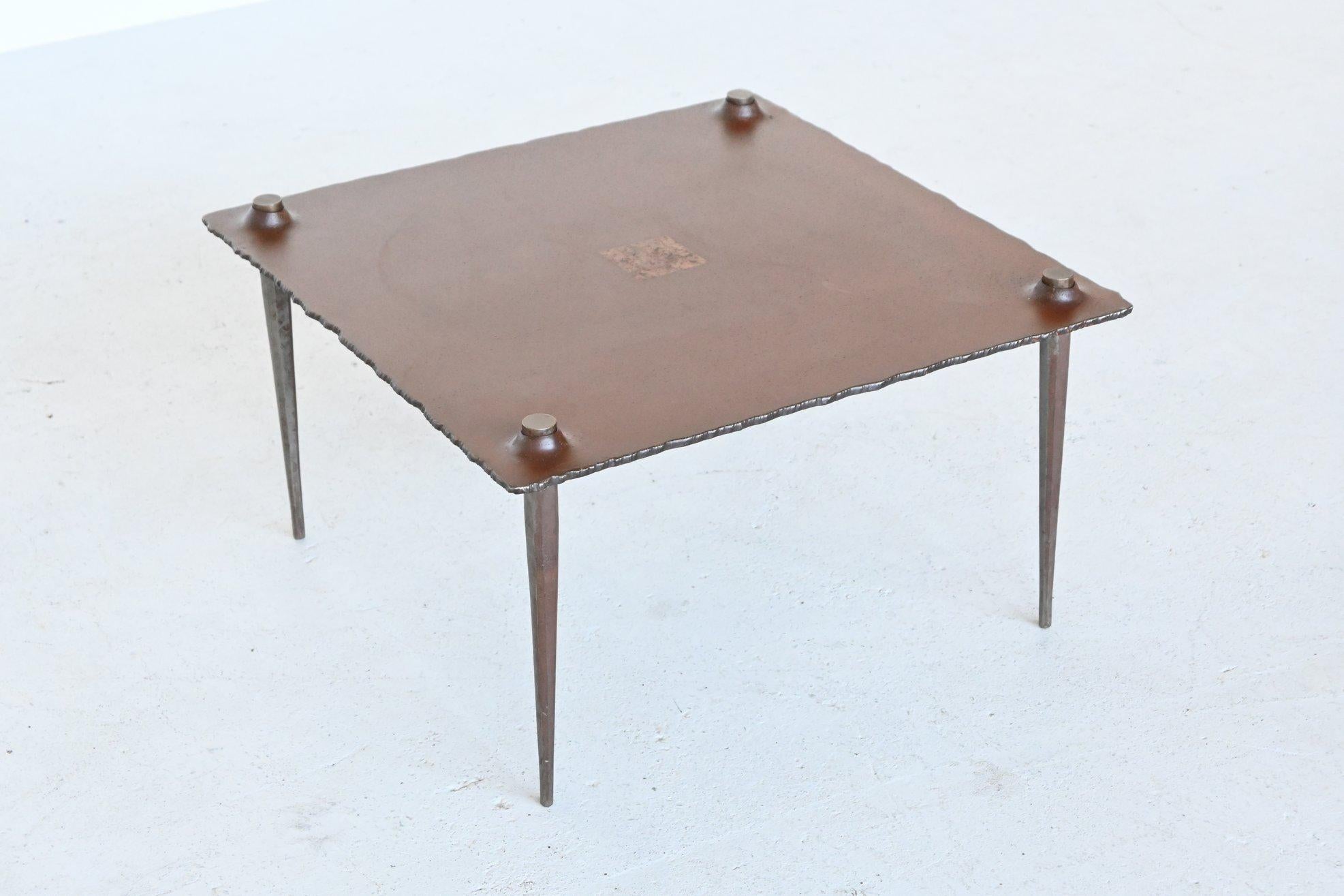 Fantastic shaped Brutalist coffee table by Idir Mecibah, produced by Smederij Moerman 1998. This table is from the scrab series designed in the end of the 1980s and produced till the end of the 1990s. It’s made of solid steel with gold leaf square