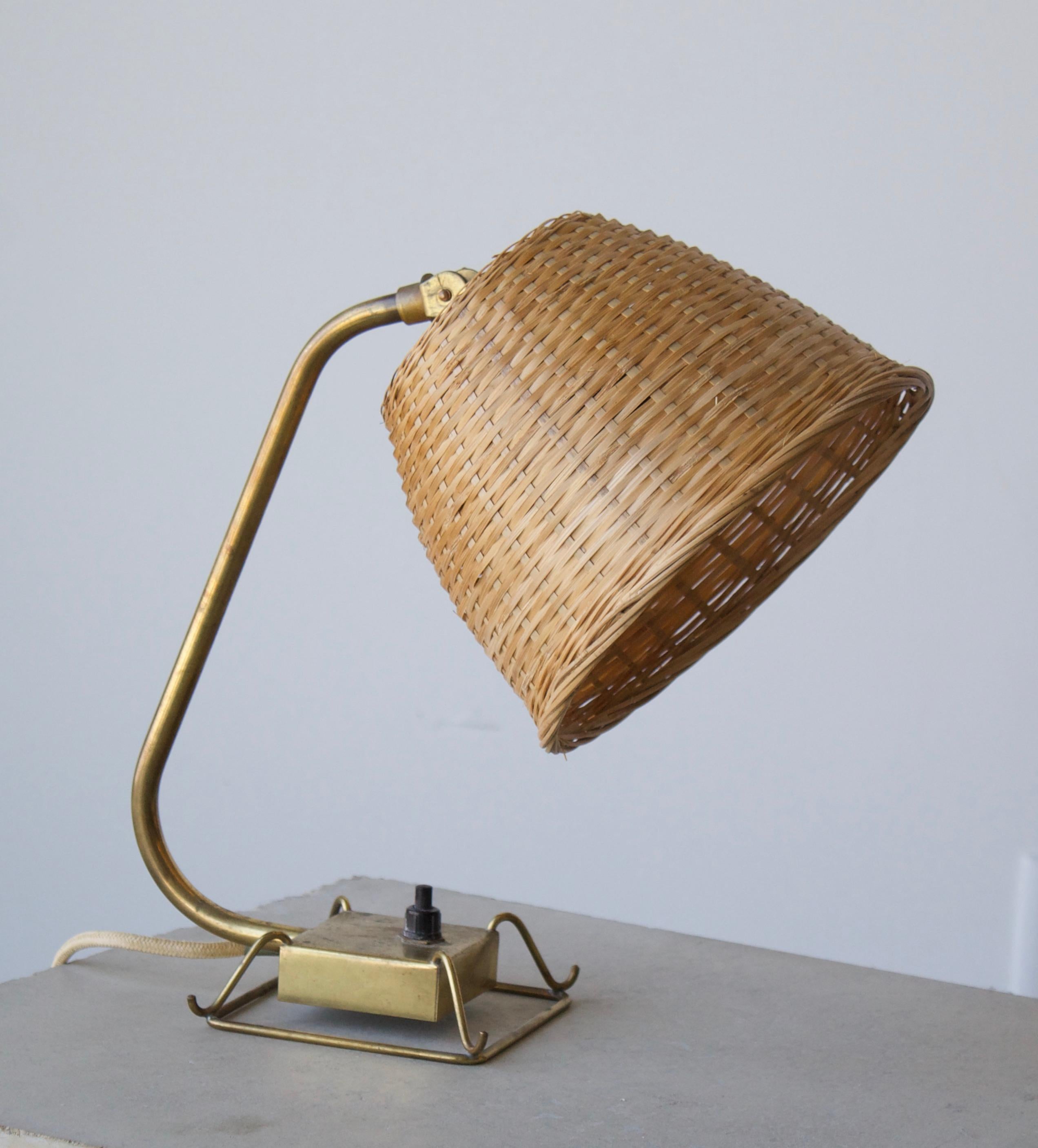 An adjustable modernist table lamp that also functions as a wall light. Designed and produced by Idman, 1950s, Finland. Assorted vintage rattan lampshade.

Other designers of the period include Paavo Tynell, Carl Axel Acking, Hans Bergström, Alvar