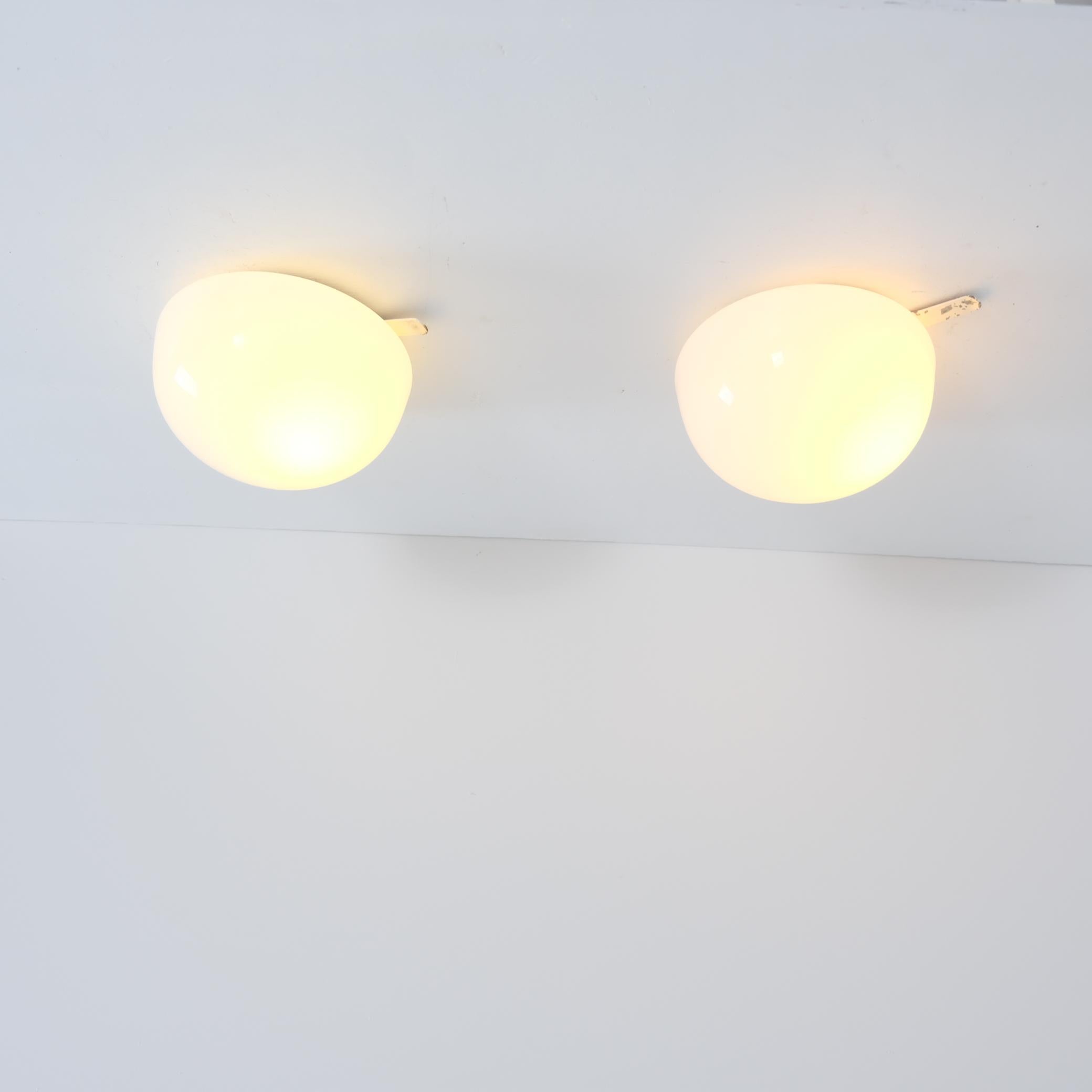An elegant pair of ceiling lamps model 80113, manufactured by Idman in Finland in the 1950s. This very minimal design fits easily into any interior. As with a lot of Scandinavian design the beauty of these lamps stems from the simplicity. Nothing