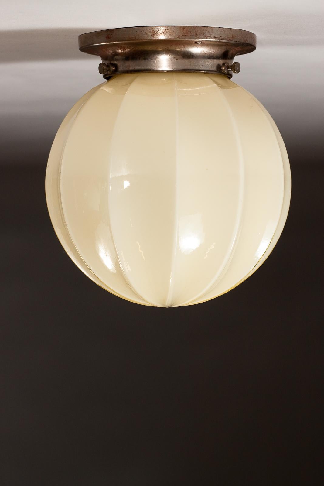 Add a touch of vintage glam to your space with this stunning 1930's opaline glass plafond lamp by Idman Oy. Crafted with exquisite attention to detail, this opulent fixture features a beautifully ribbed opaline glass shade that diffuses a soft, warm