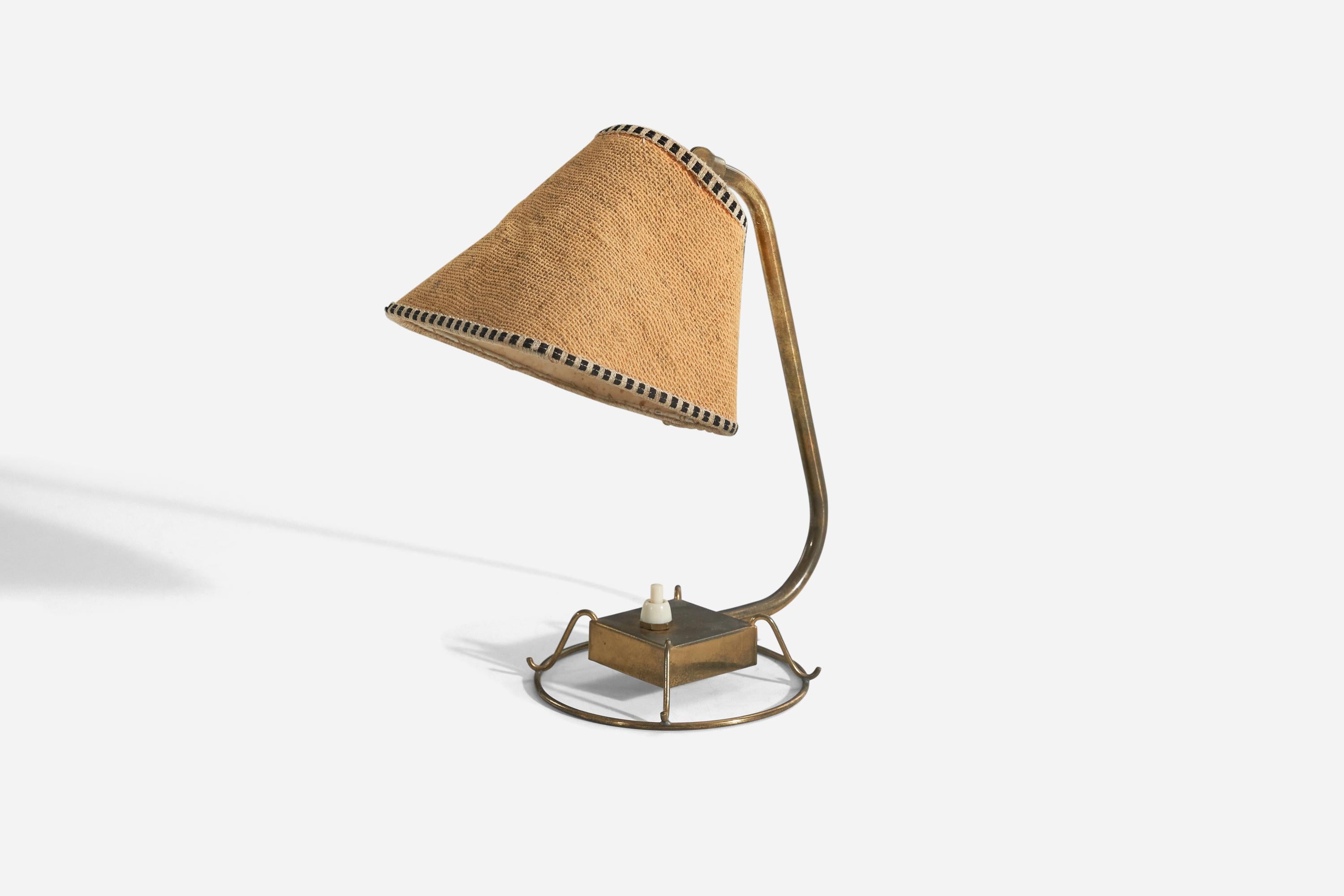 A brass and fabric table lamp designed and produced by Idman Oy, Finland, 1940s.

Variable dimensions, measured as illustrated in the first image. 
Sold with lampshade. 
Stated dimensions refer to the lamp with the shade.