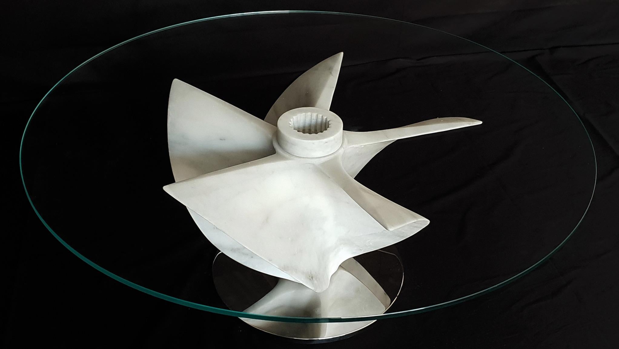 The Idro Propellor Table is a collaborative effort created with Silvestri Marmi in Carrara, Italy and designer Damiano Spelta of Milano. 

This contemporary nautically themed table is created in white Carrara Marble with a steel base. A truly