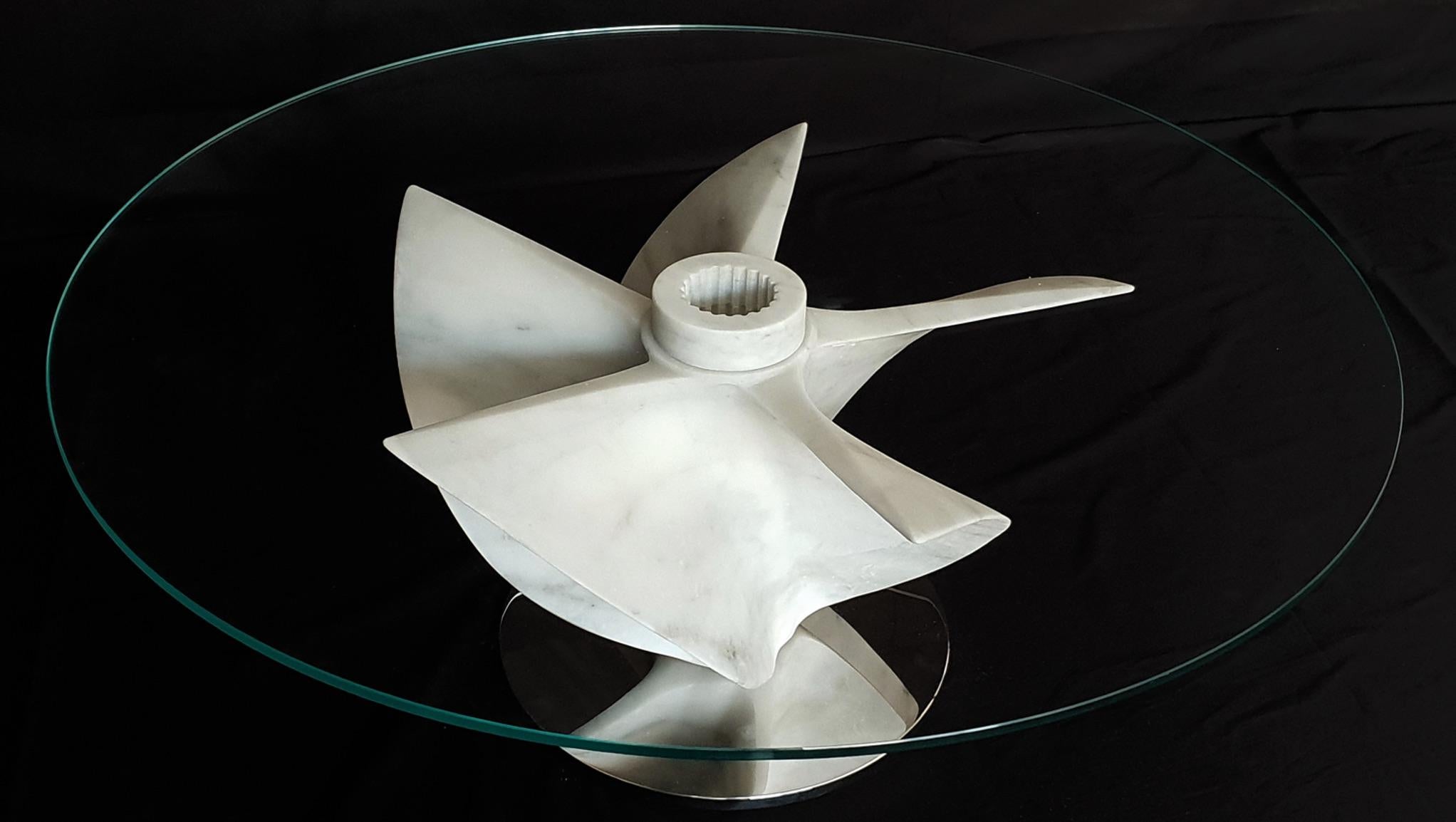 The Idro Propellor table is a collaborative effort created with Silvestri Marmi in Carrara, Italy and designer Damiano Spelta of Milano. 

This contemporary nautically themed table is created in white Carrara Marble with a steel base. A truly