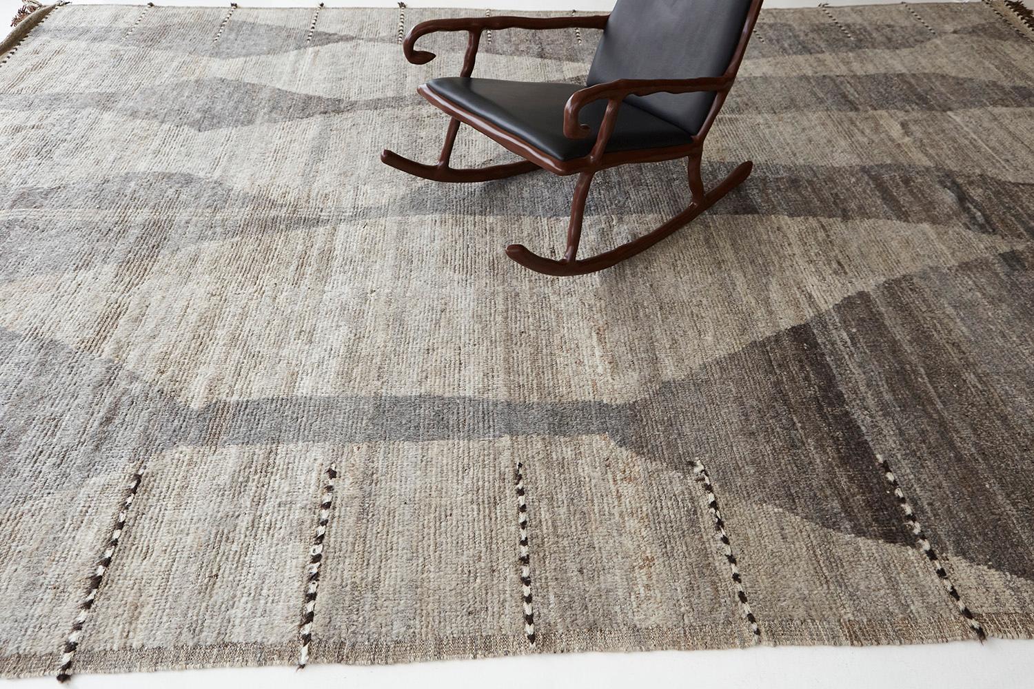 Featuring a beautiful abrash of this contemporary rug called Ifassen' that boasts its fluid details of gray and natural brown. Fascinating tassels complement the overall appeal of this mesmerizing work of art. One of the most sought-after pieces