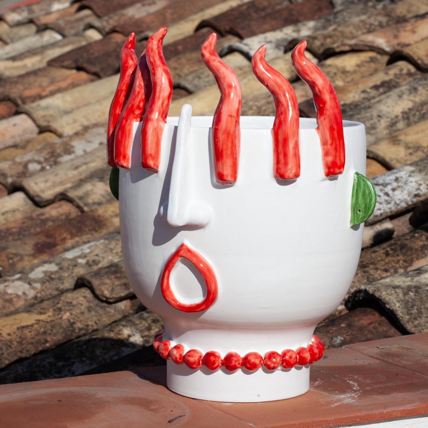 This striking sculpture/vase results from the impeccable mastery and visionary sensibility of ceramist Patrizia Italiano that personally handcrafts each piece. Part of a series dedicated to Sicilian street vendors, this superb anthropomorphic piece